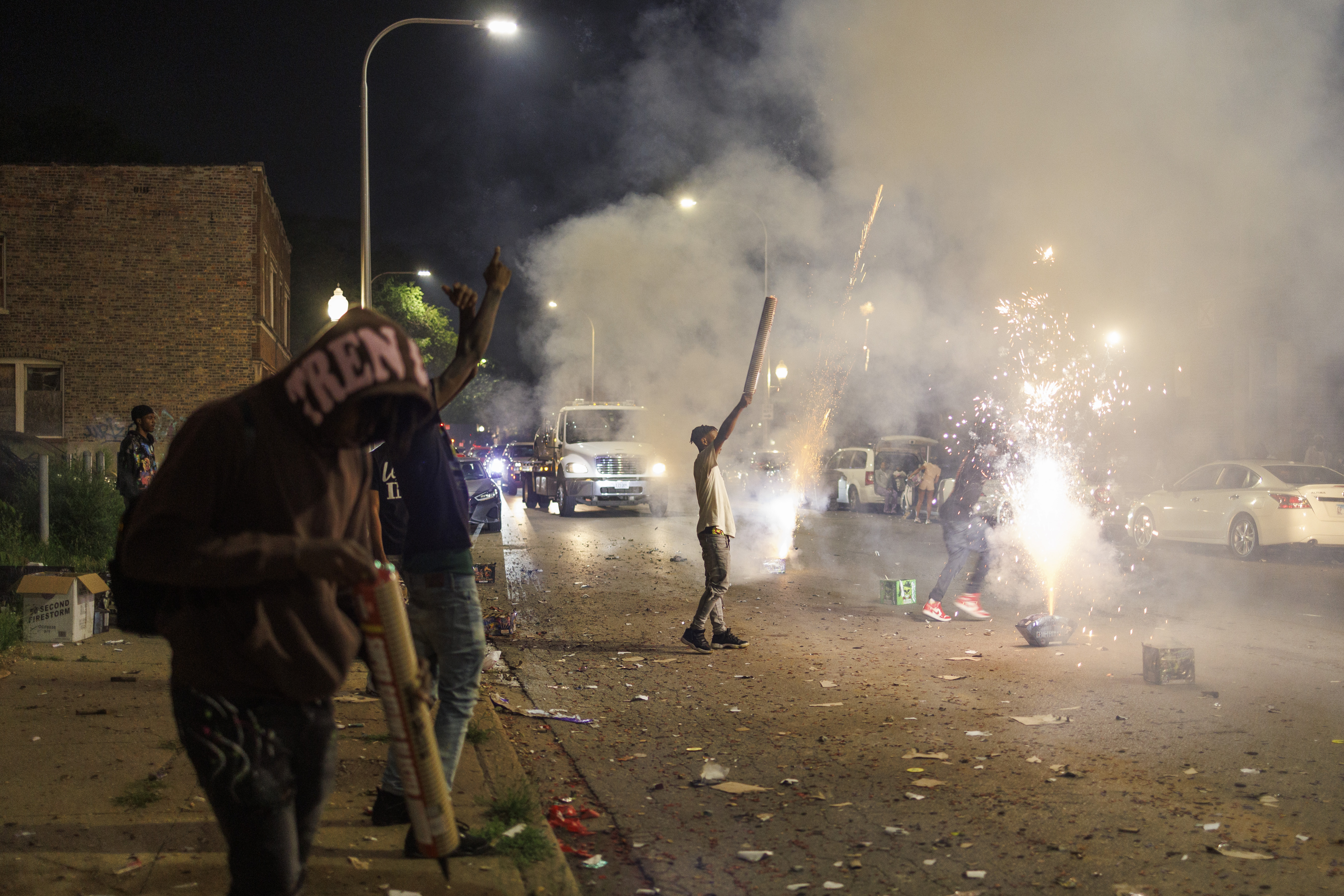 Residents launch fireworks near the sidewalk and road on West 59th Street in Chicago's Englewood neighborhood on July 4, 2024. (Armando L. Sanchez/Chicago Tribune)