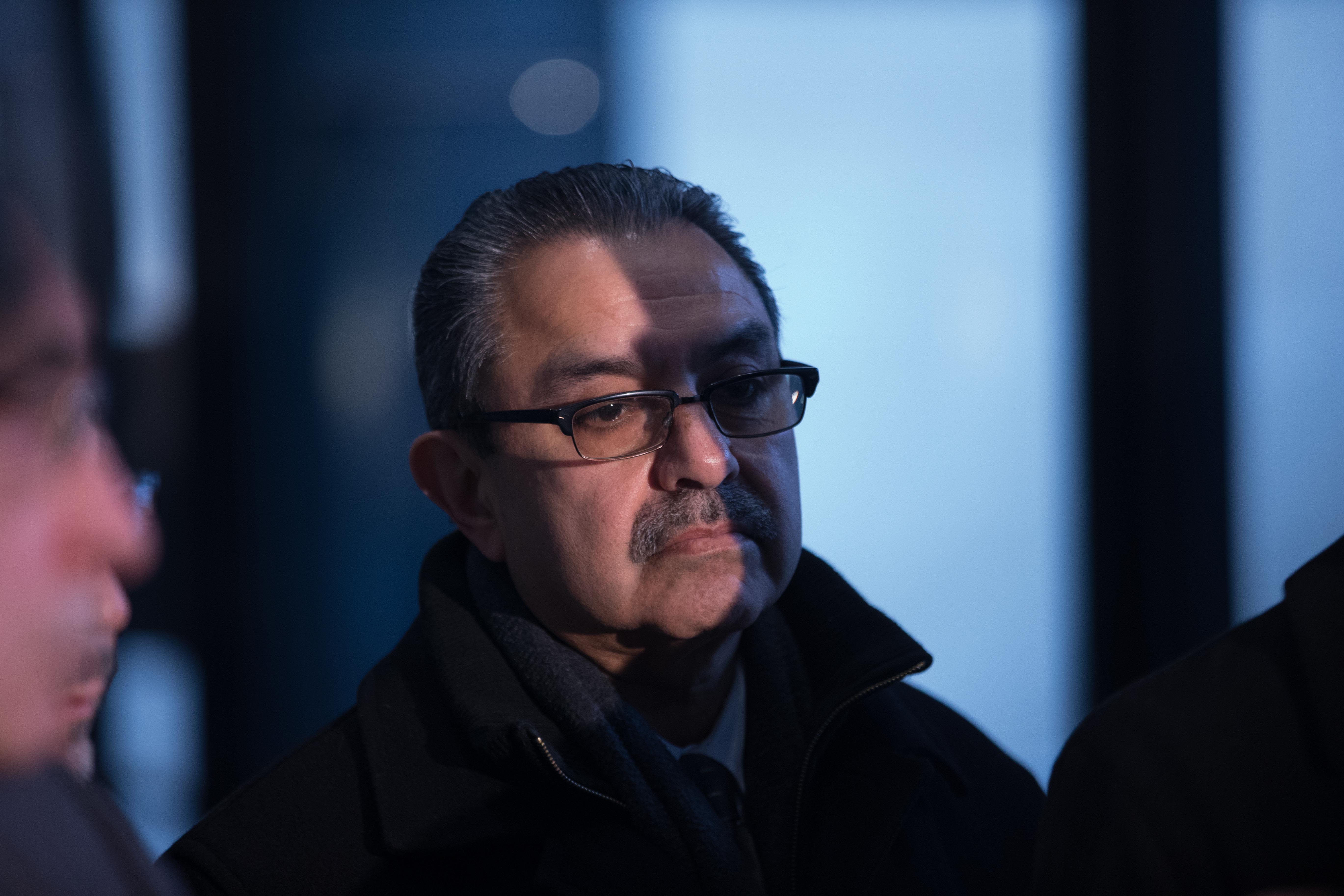 Ex-Chicago Ald. Ambrosio Medrano stands in the shadow of his lawyer during a press conference after he was sentenced on Jan. 10, 2014, at the Dirksen U.S. Courthouse in Chicago. (Alex Garcia/Chicago Tribune)