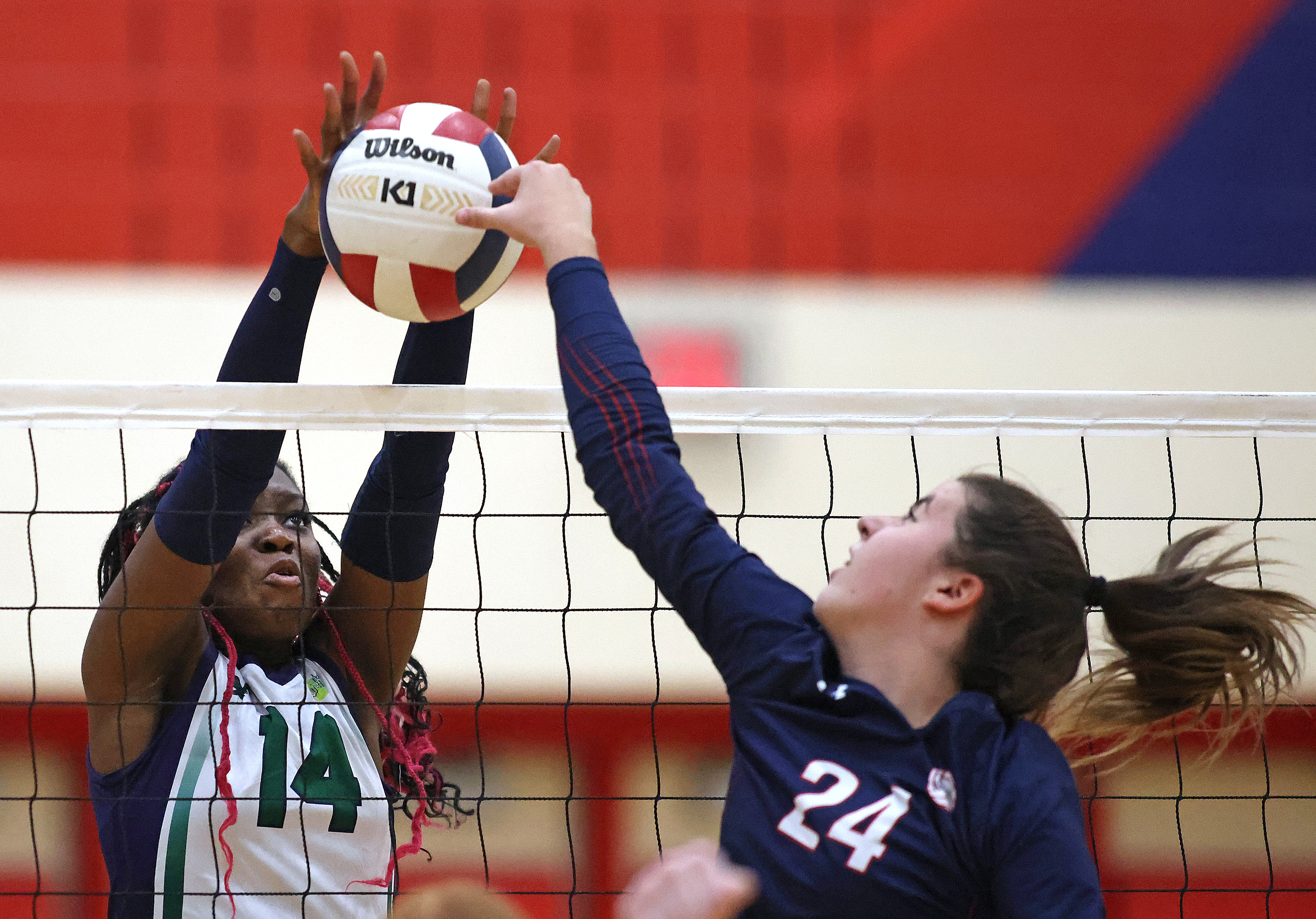 Bartlett's Elsie Nwabuego (14) blocks a tipped ball bay South Elgin's Paige Genke (24) during a Upstate Eight Conference game on Tuesday, Sept. 17, 2024 in South Elgin. (H. Rick Bamman / The Beacon News)