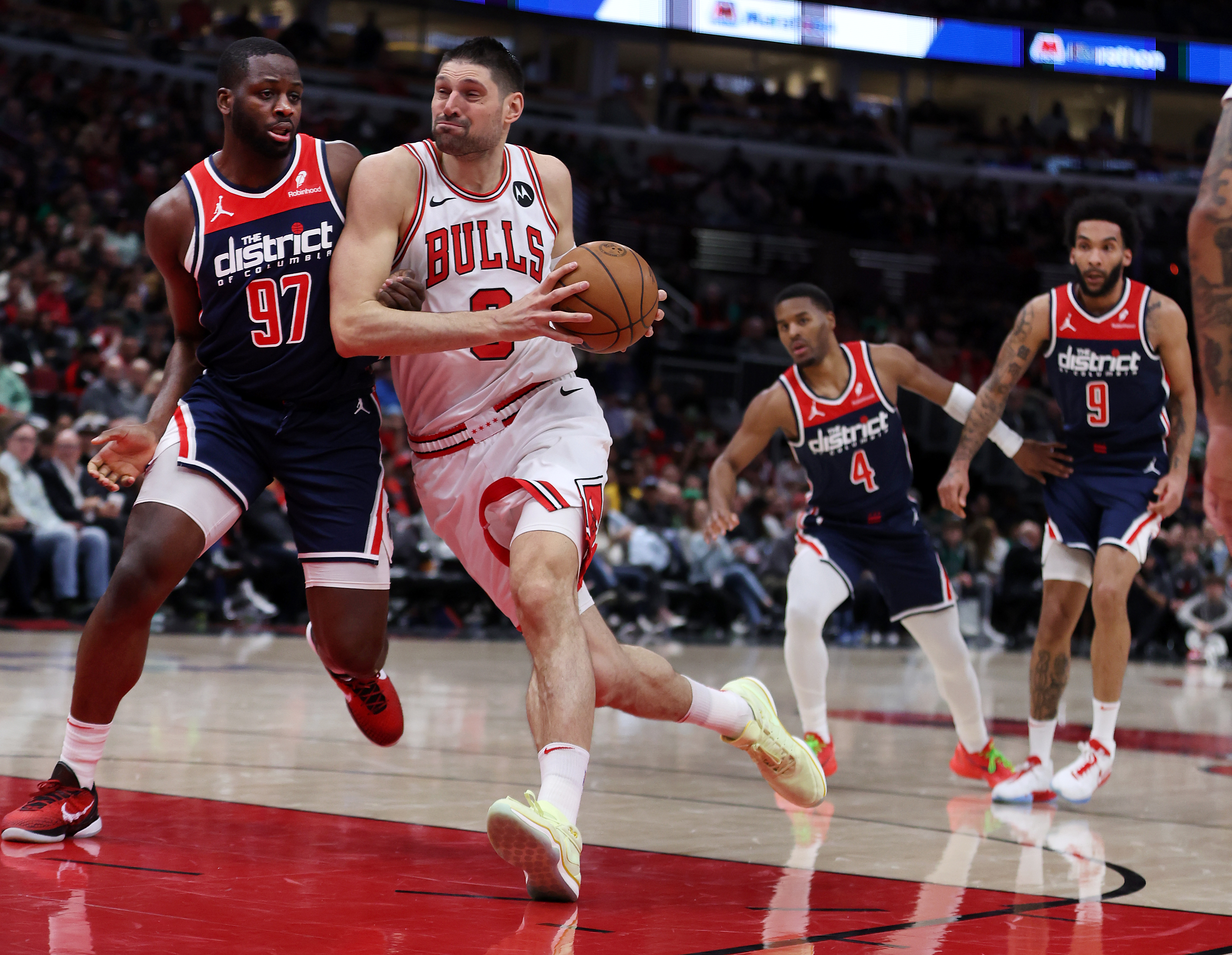 Bulls center Nikola Vučević drives on the Wizards' Eugene Omoruyi in the first half at the United Center on March 16, 2024. (Chris Sweda/Chicago Tribune)