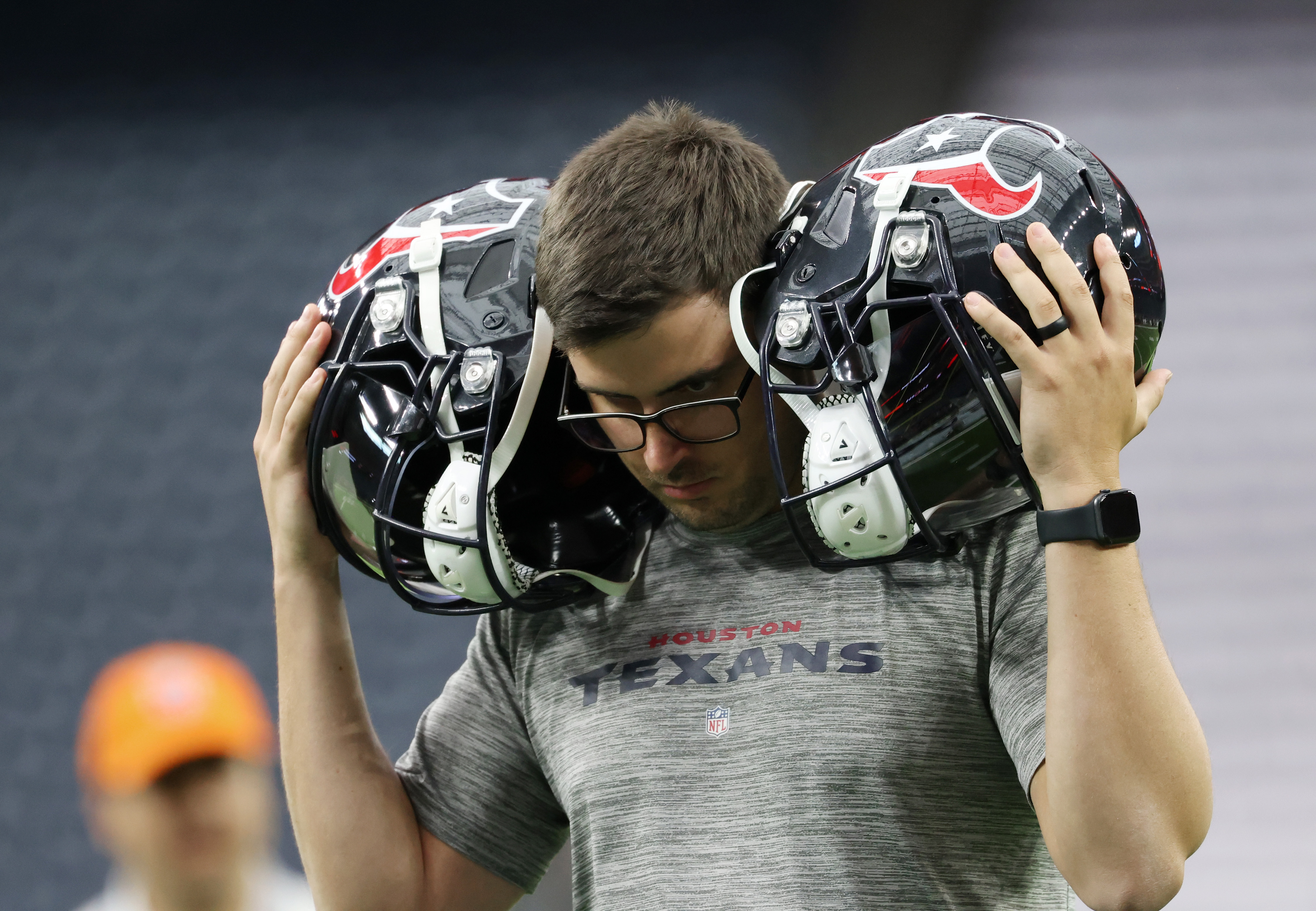 A Texans team worker checks the audio systems on players' helmets before a game against the Bears at NRG Stadium on Sept. 15, 2024, in Houston. (John J. Kim/Chicago Tribune)