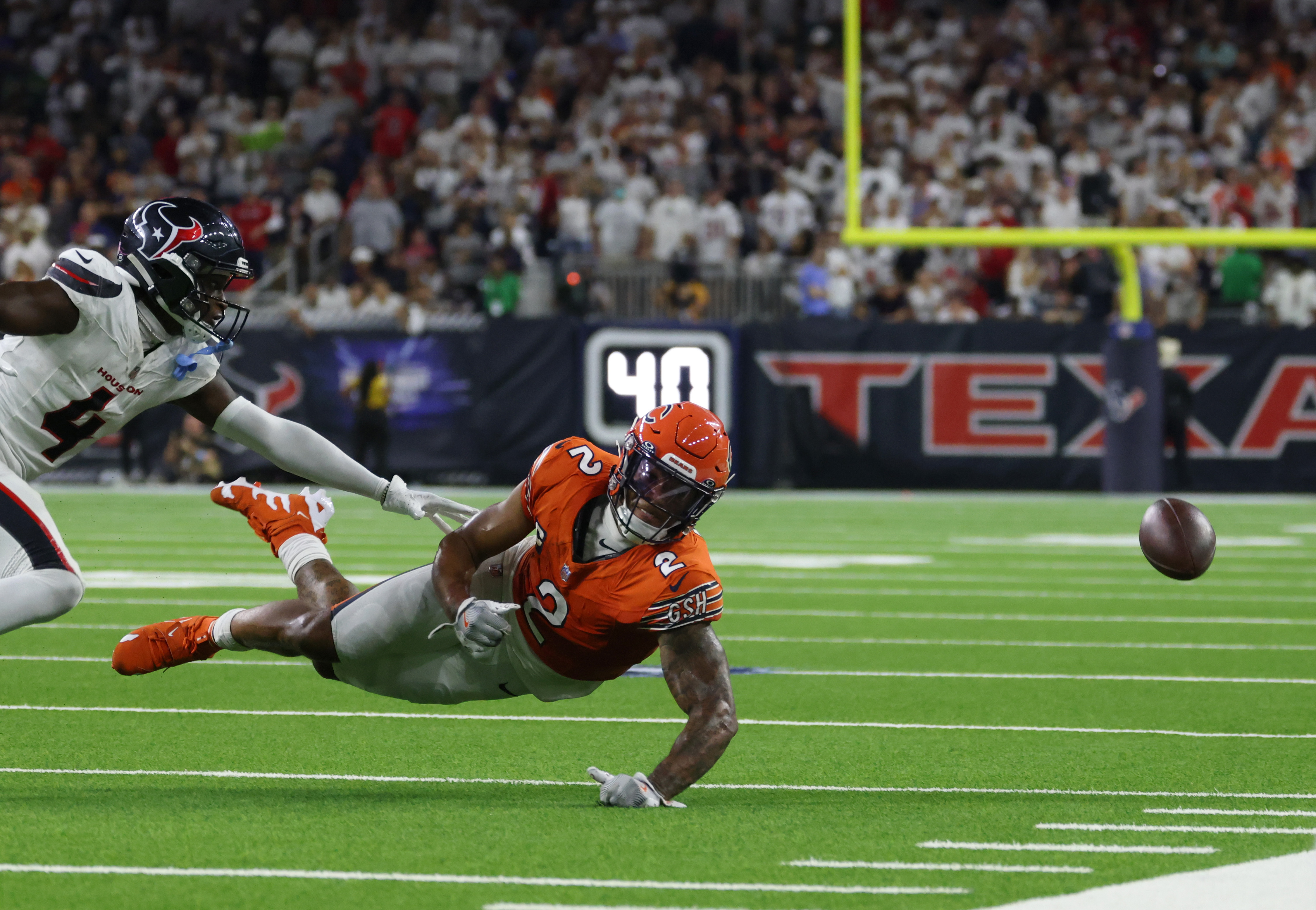 The ball flies past Bears wide receiver DJ Moore as Texans cornerback Kamari Lassiter defends in the fourth quarter at NRG Stadium on Sept. 15, 2024, in Houston. (John J. Kim/Chicago Tribune)