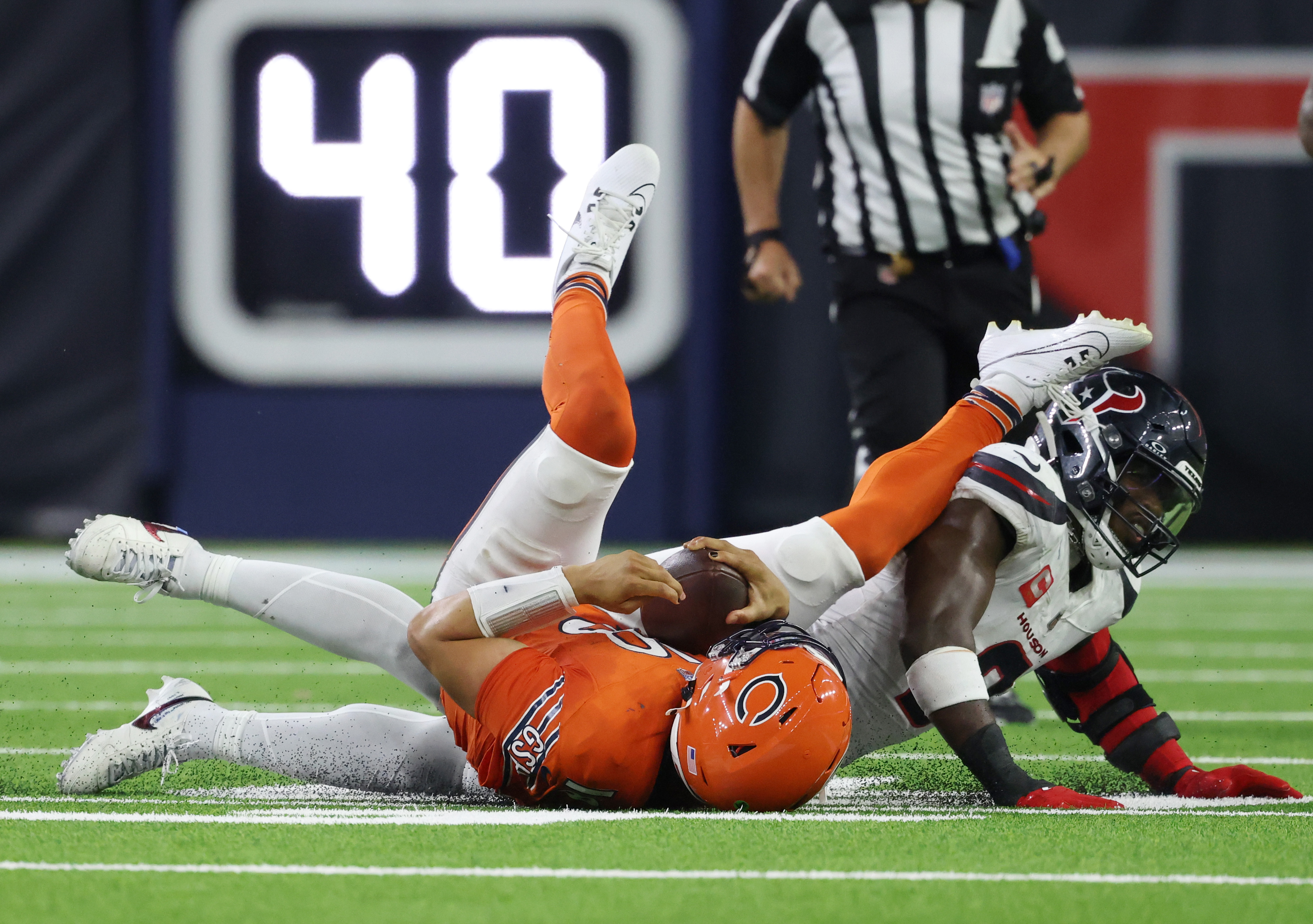 Bears quarterback Caleb Williams is sacked by Texans linebacker Azeez Al-Shaair in the fourth quarter at NRG Stadium on Sept. 15, 2024, in Houston. (John J. Kim/Chicago Tribune)