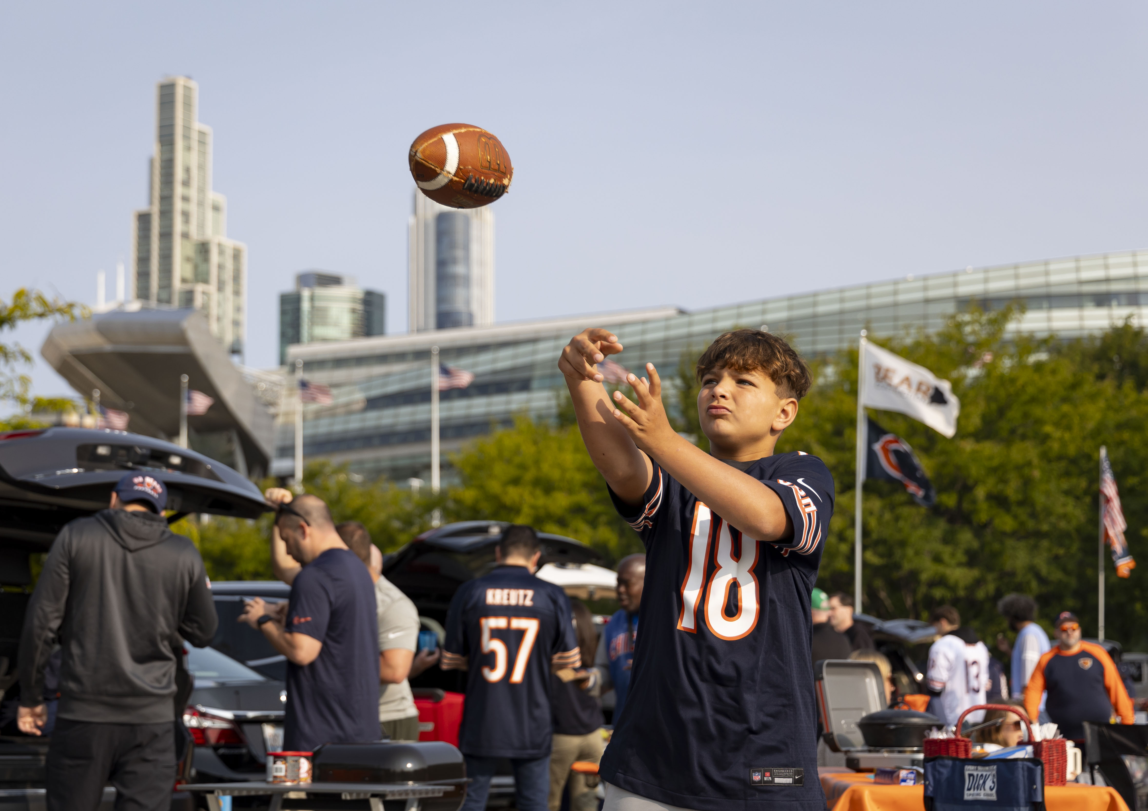 Javie Lents celebrates his 11th birthday throwing a football outside before the Chicago Bears face the Tennessee Titans in the season opener on Sunday, Sept. 8, 2024, at Soldier Field. (Brian Cassella/Chicago Tribune)