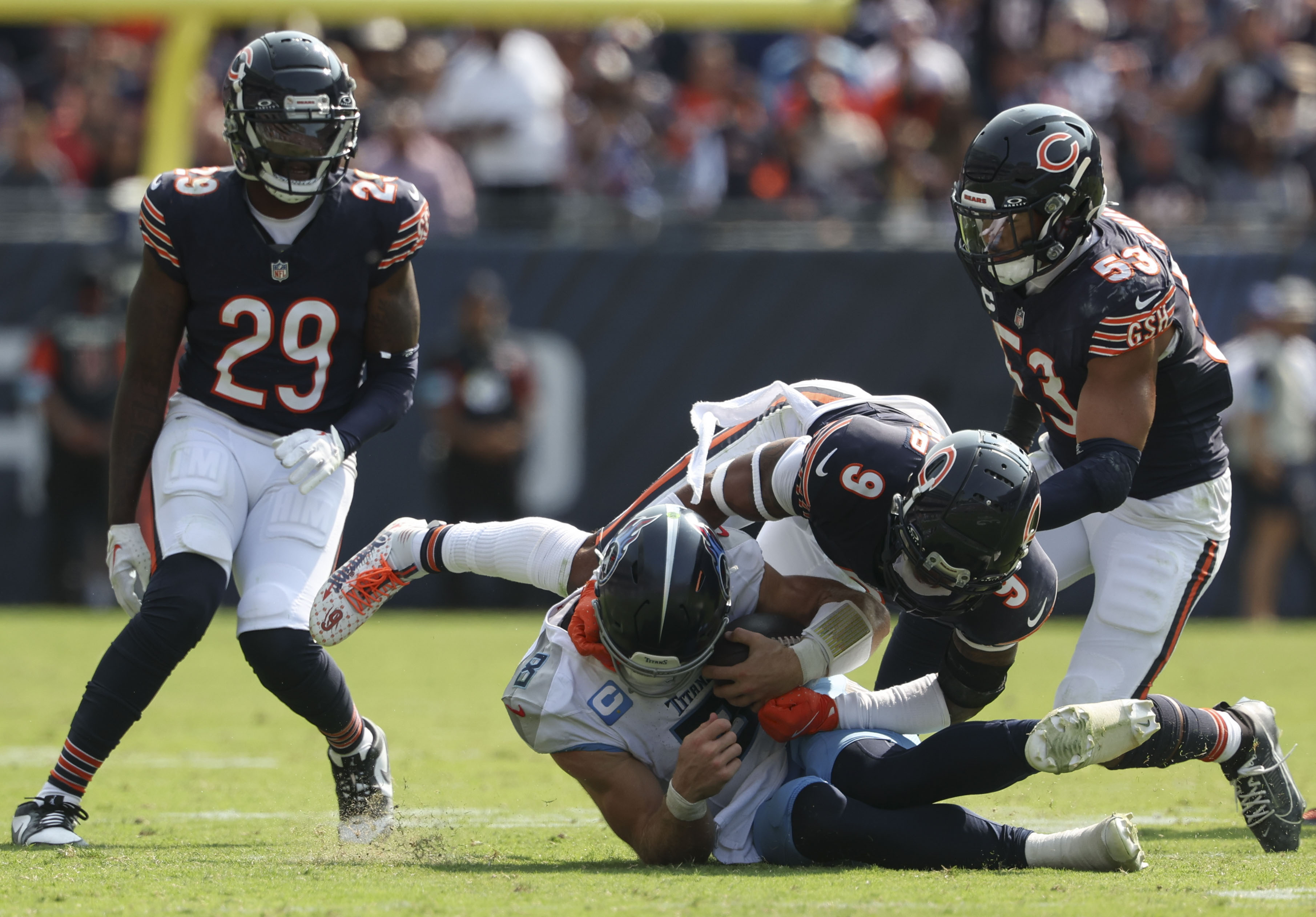 Chicago Bears safety Jaquan Brisker, 9, tackles Tennessee Titans quarterback Will Levis, 8, in the fourth quarter at Soldier Field. (Brian Cassella/Chicago Tribune)