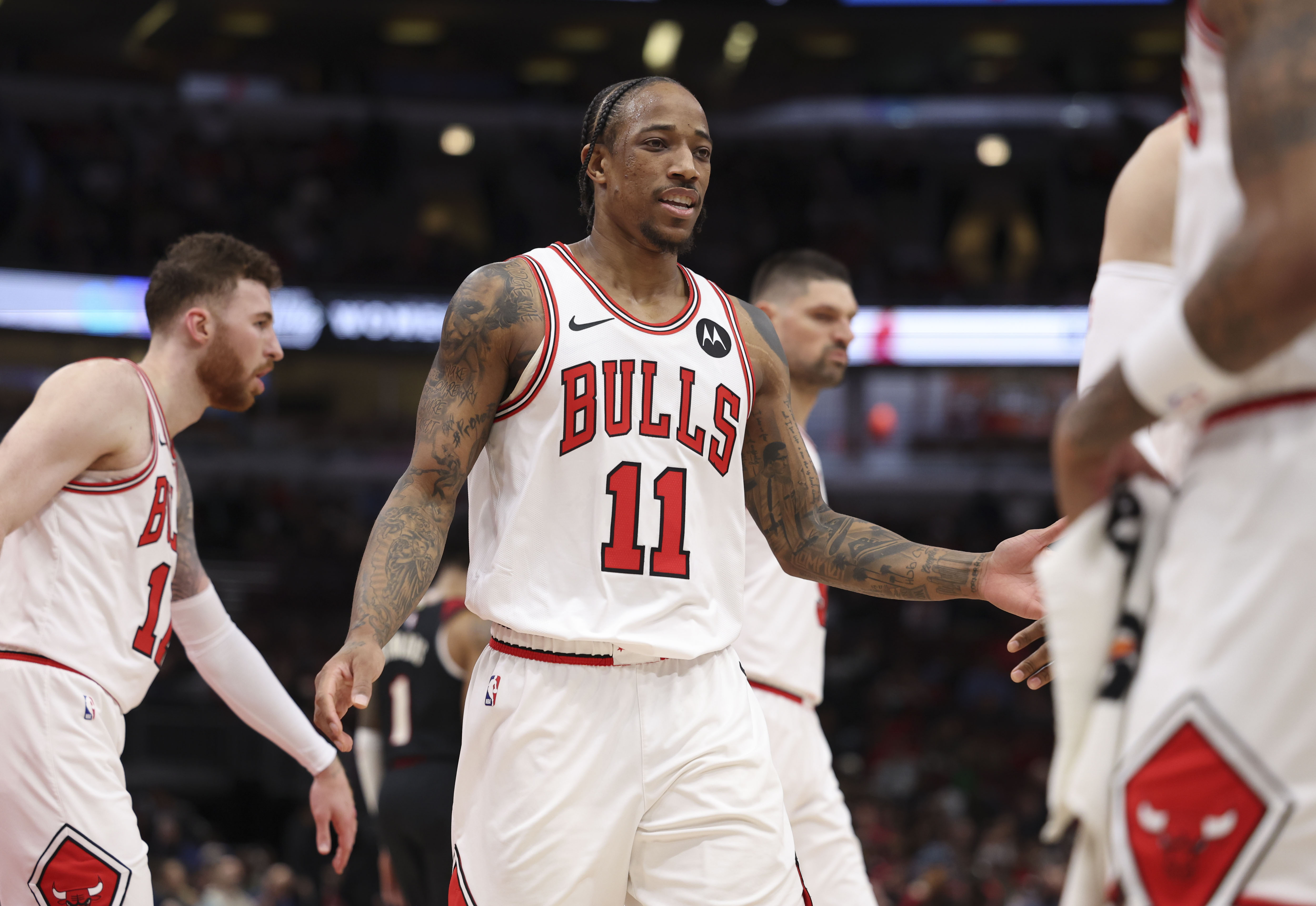 DeMar DeRozan celebrates with Bulls teammates in the first half on March 18, 2024, at the United Center. (Brian Cassella/Chicago Tribune)