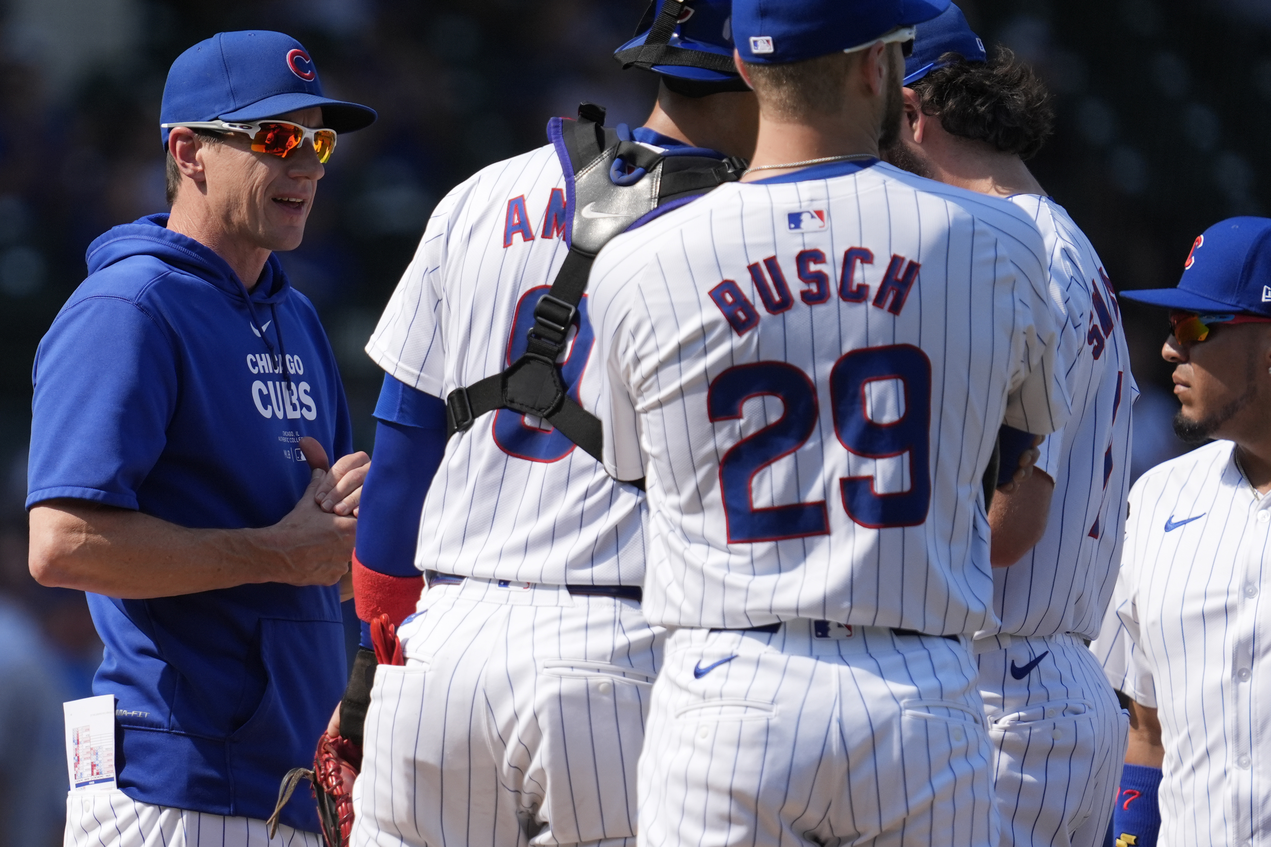 Cubs manager Craig Counsell, left, talks with players during a visit to the mound in the third inning Wednesday, Sept. 18, 2024, at Wrigley Field. (AP Photo/Nam Y. Huh)