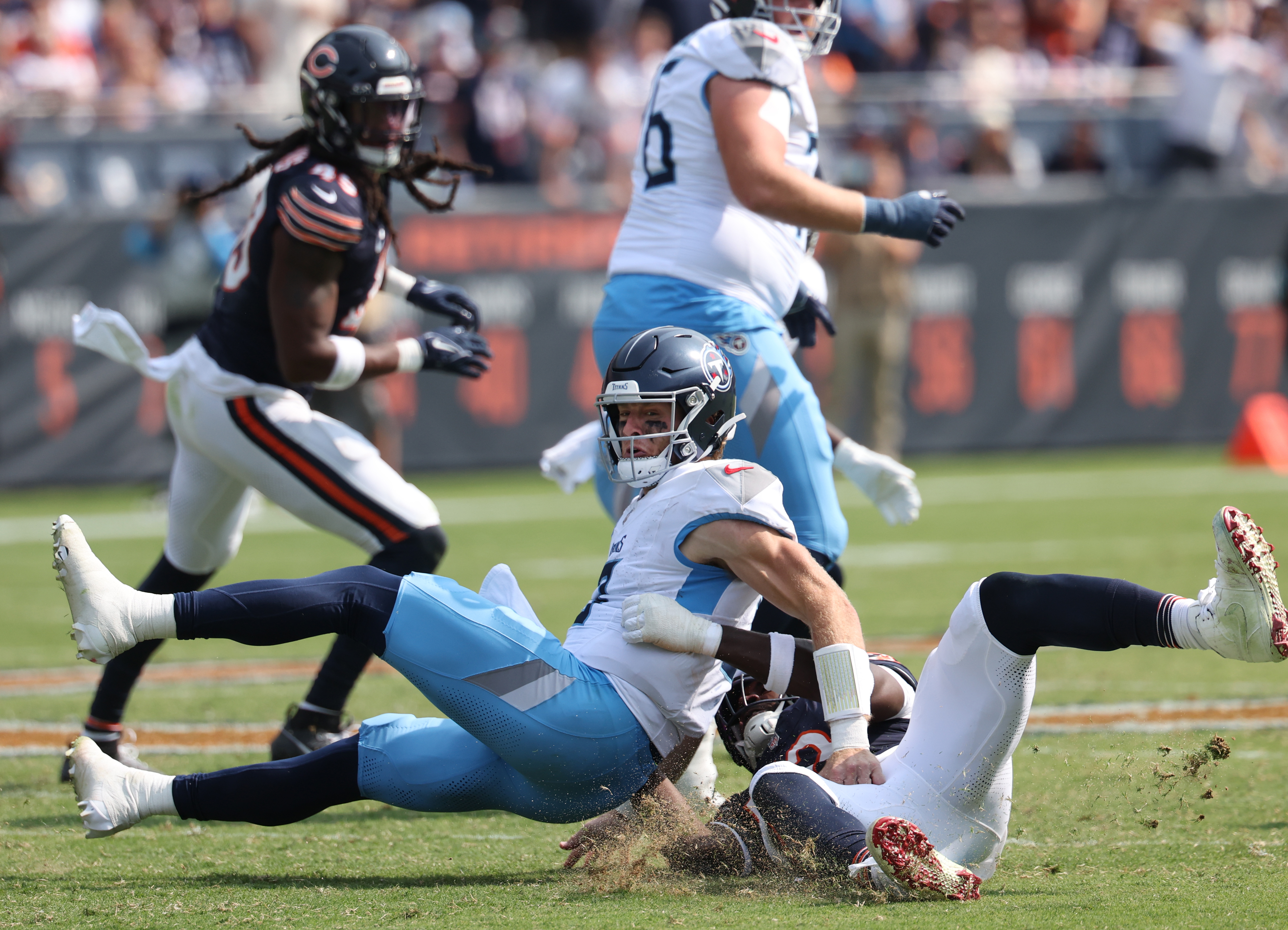 Tennessee Titans quarterback Will Levis, 8, is pulled to the ground by Chicago Bears defensive end Darrell Taylor, 52, in the fourth quarter of a game at Soldier Field in Chicago on Sept. 8, 2024. Levis fumbled on the play. (Chris Sweda/Chicago Tribune)