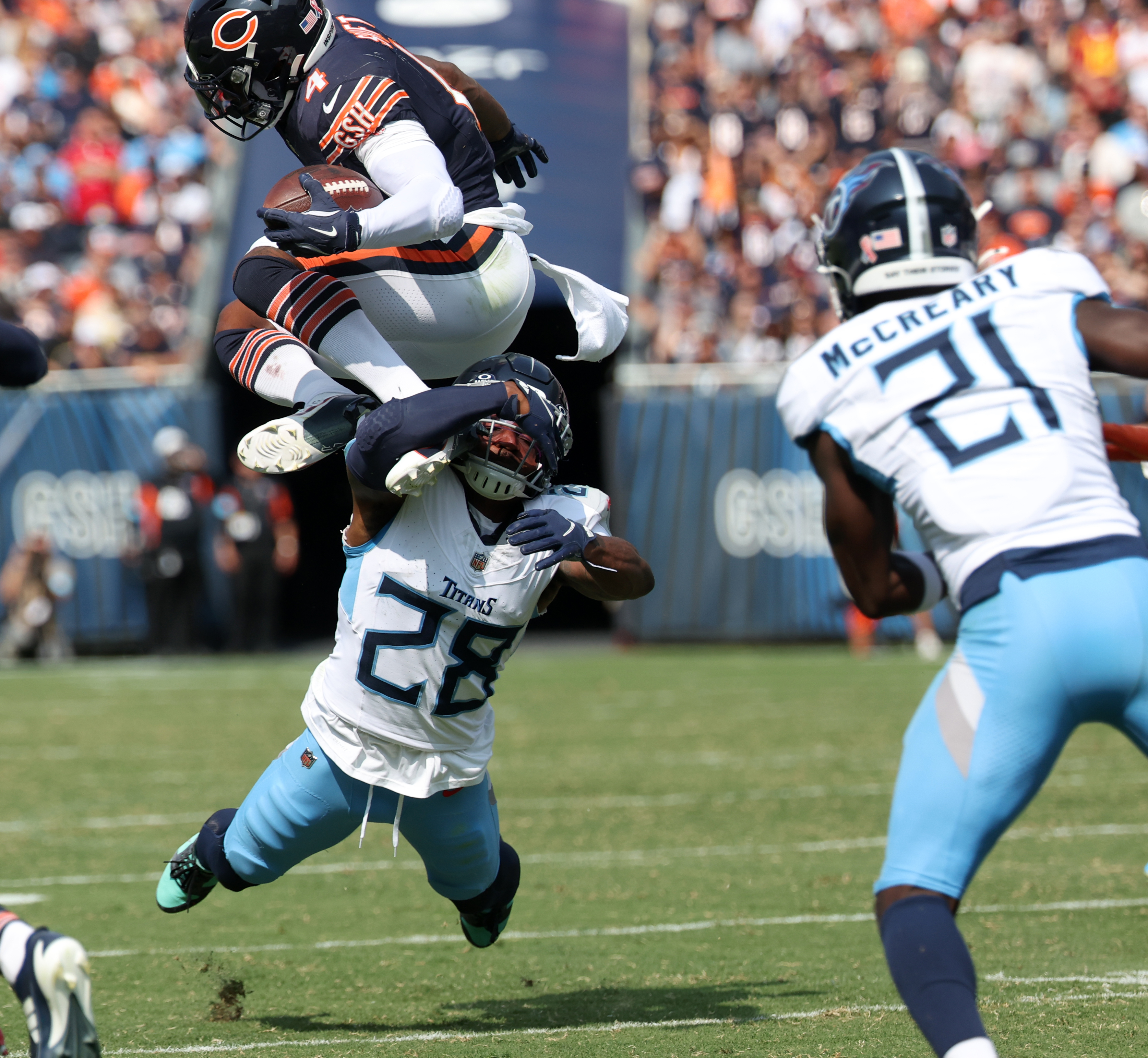 Chicago Bears running back D'Andre Swift, 4, leaps over Tennessee Titans safety Quandre Diggs, 28, in the fourth quarter of a game at Soldier Field on Sunday. (Chris Sweda/Chicago Tribune)