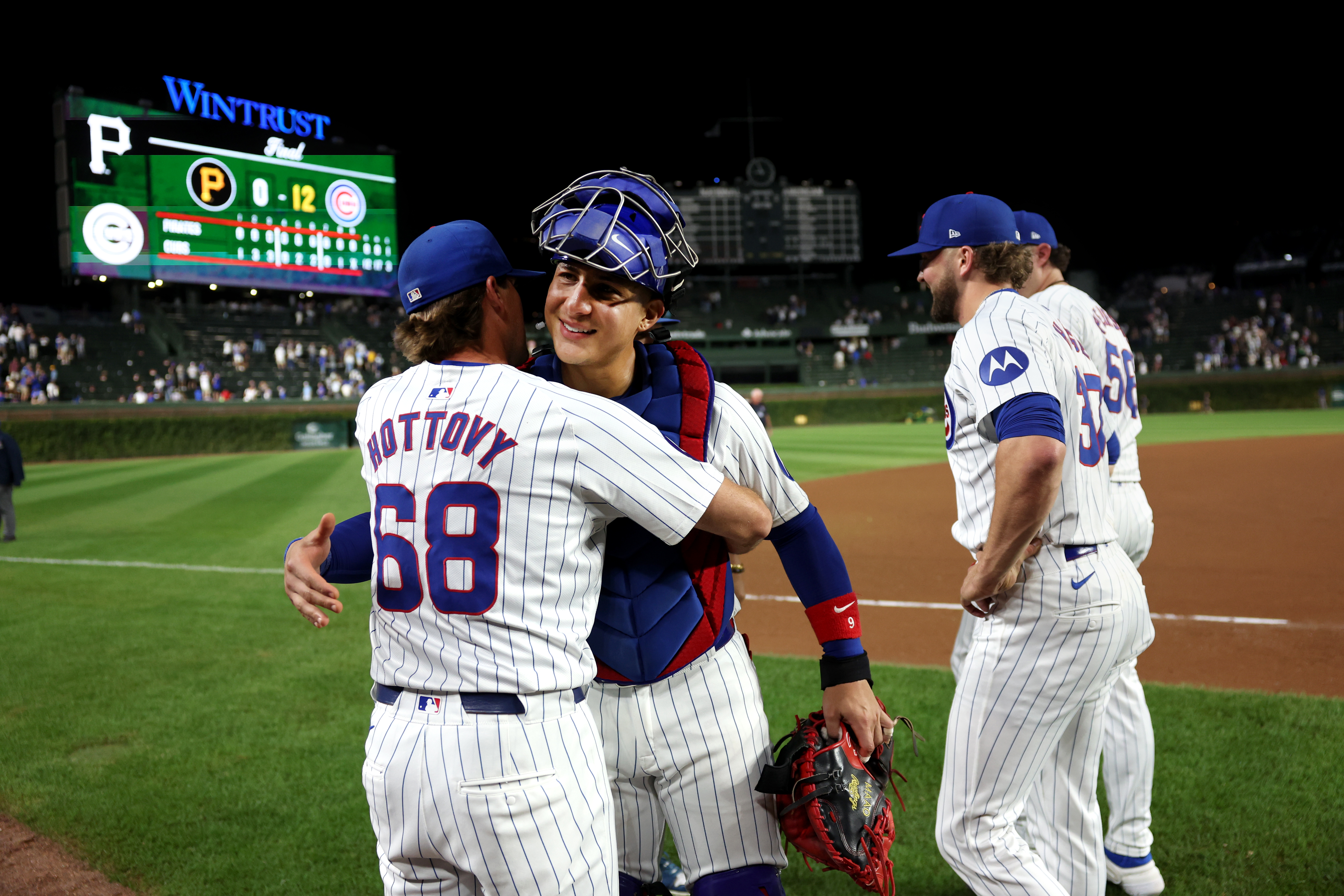 Chicago Cubs catcher Miguel Amaya and pitching coach Tommy Hottovy (68) embrace after Amaya, along with pitchers Shota Imanaga, Nate Pearson, and Porter Hodge, combined for a no-hitter against the Pittsburgh Pirates at Wrigley Field in Chicago on Sept. 4, 2024. (Chris Sweda/Chicago Tribune)