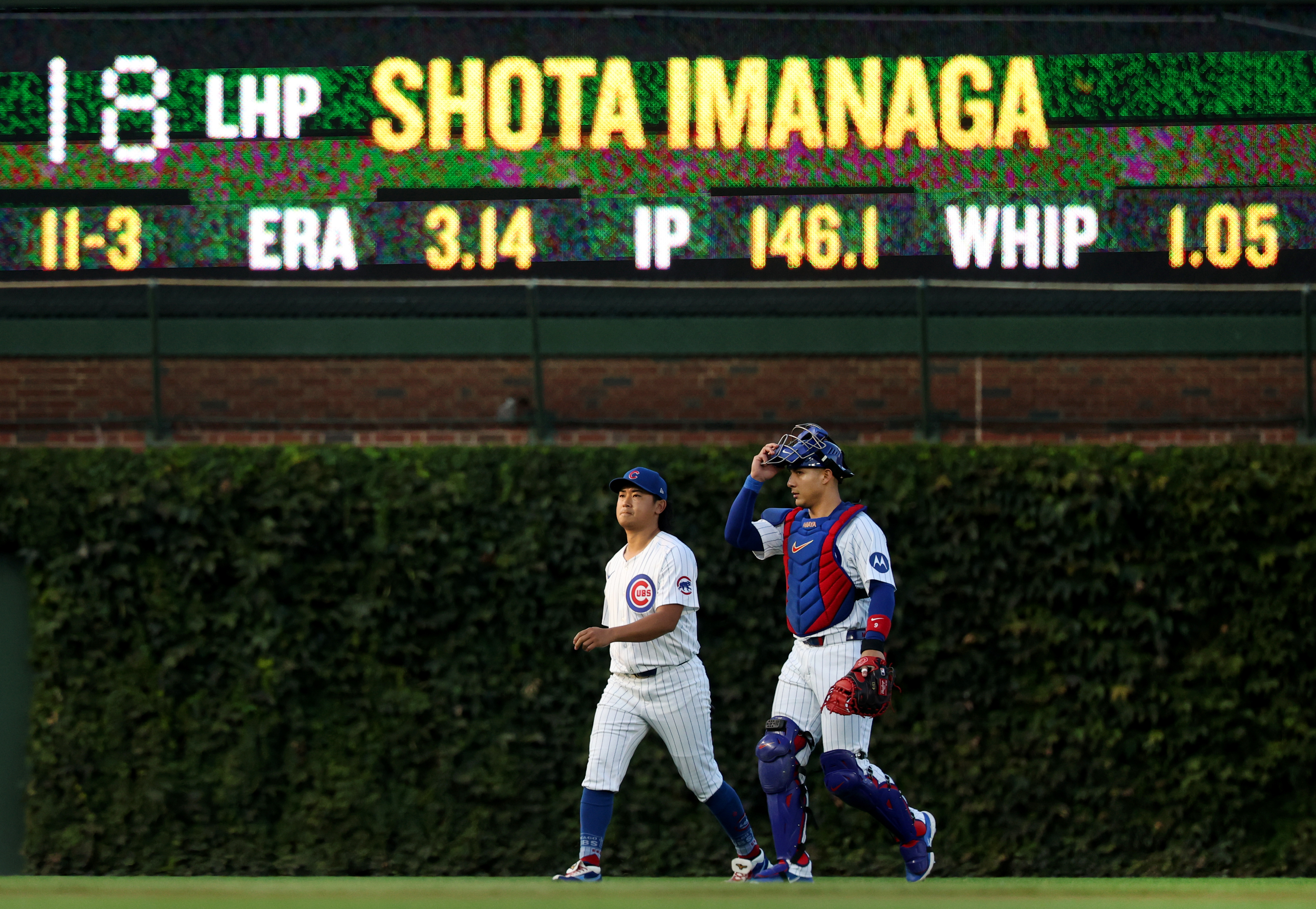 Chicago Cubs pitcher Shota Imanaga and catcher Miguel Amaya walk from the bullpen to the dugout before the start of a game against the Pittsburgh Pirates at Wrigley Field in Chicago on Sept. 4, 2024. (Chris Sweda/Chicago Tribune)