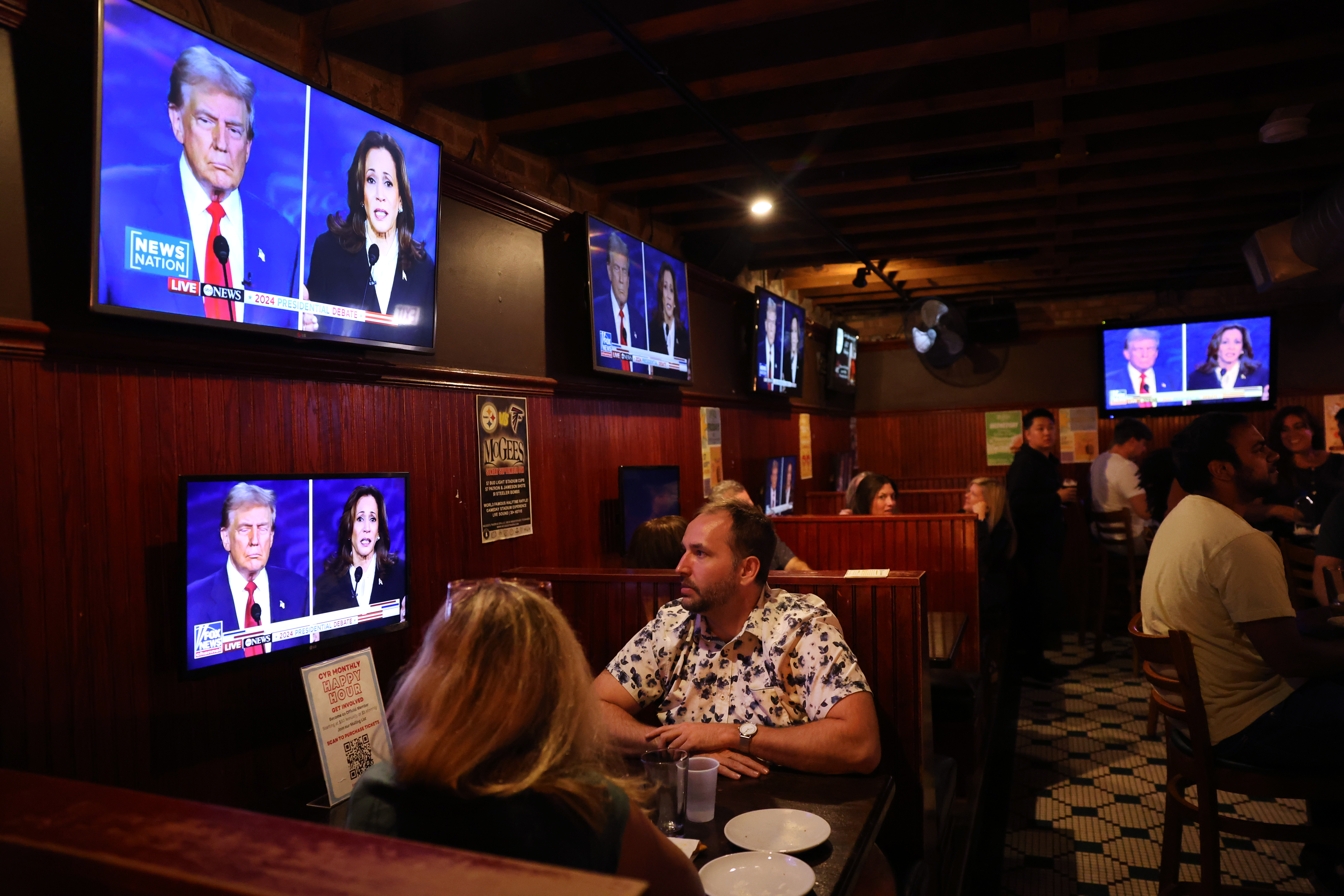 People attending a watch party hosted by Chicago Young Republicans at McGee's Tavern in Chicago's Lincoln Park neighborhood take in the presidential debate between Donald Trump and Kamala Harris on Sept. 10, 2024. (Chris Sweda/Chicago Tribune)