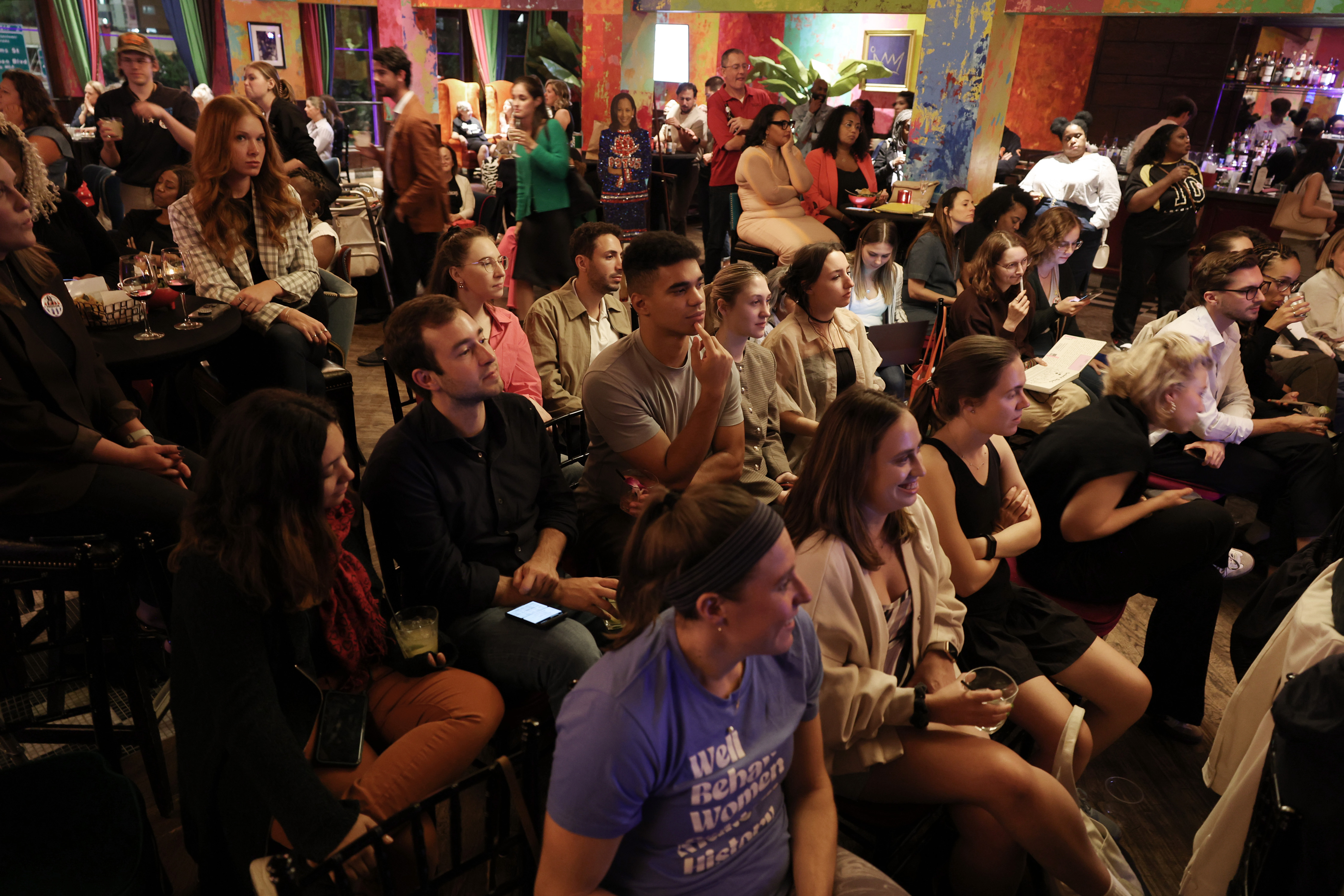 Prospective voters listen to the presidential debate during a watch party at Carnivale restaurant on Sept. 10, 2024, in Chicago. (John J. Kim/Chicago Tribune)