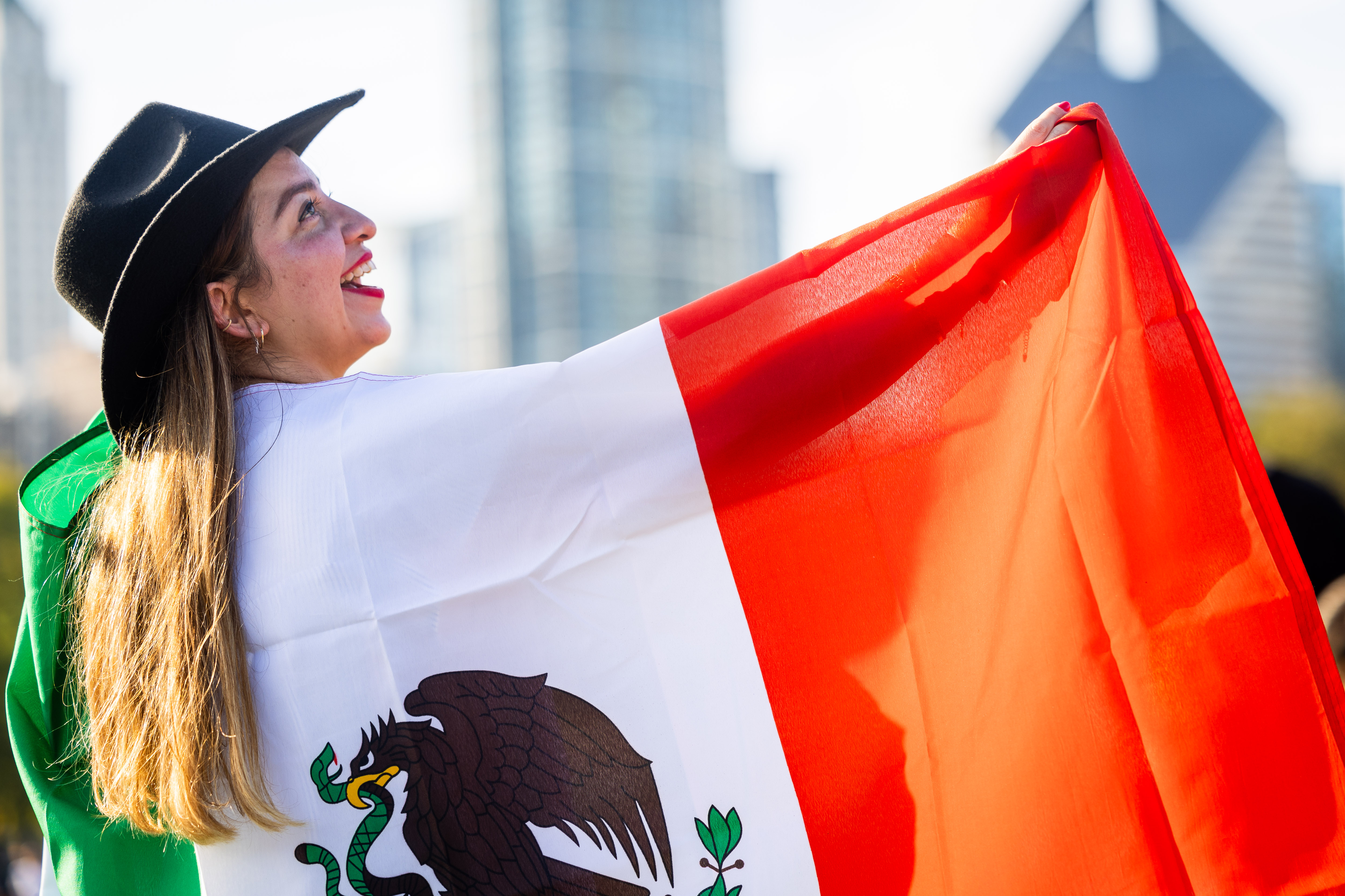 Alejandra Portillo poses for a photo from a friend at El Grito Chicago, a two-day festival in celebration of Mexican Independence Day, at Grant Park's Butler Field in Chicago on Sept. 14, 2024. (Tess Crowley/Chicago Tribune)