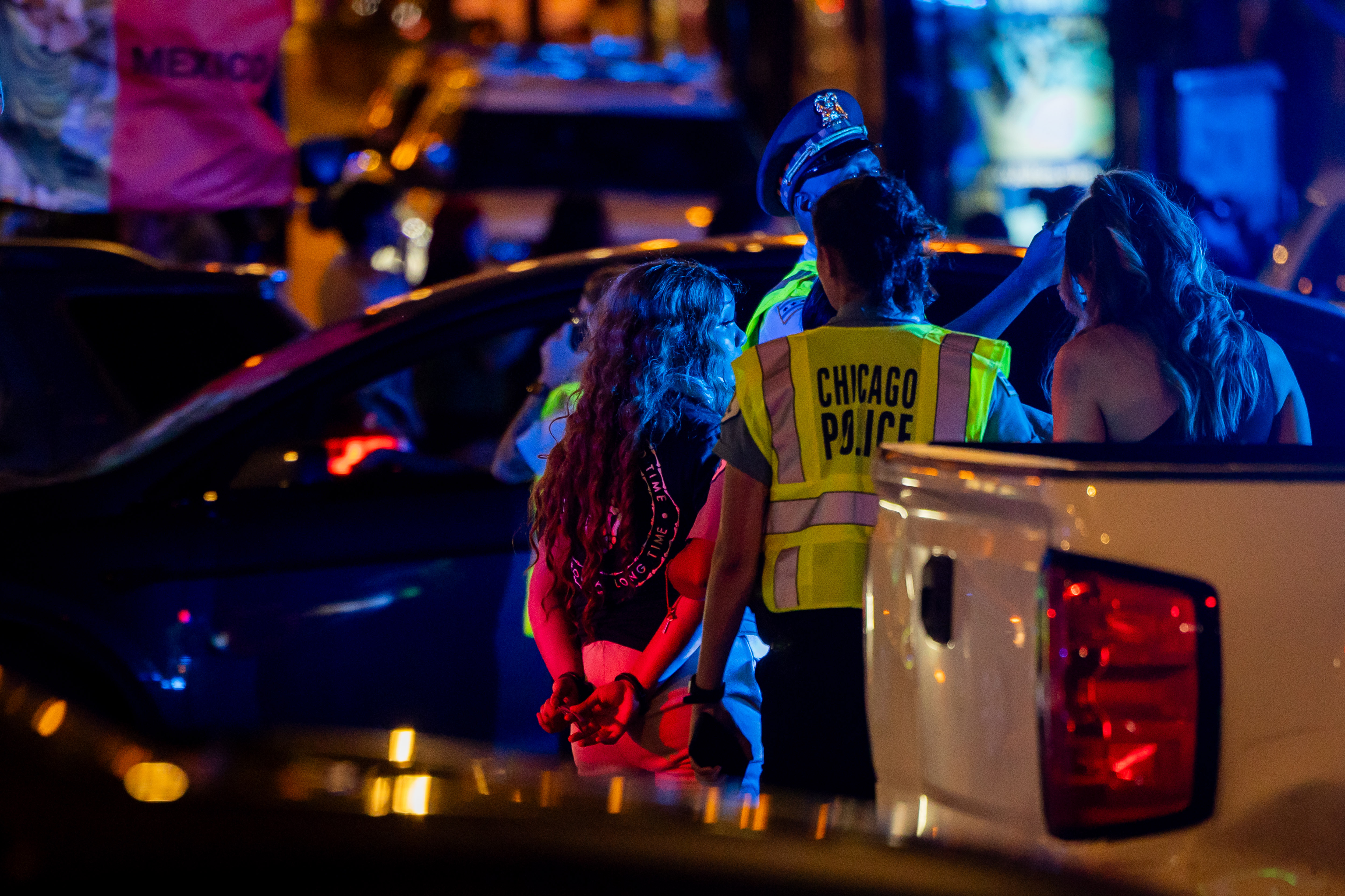 Police stop a car in search of fireworks on Michigan Avenue during a celebration of Mexican Independence Day in Chicago on Sept. 14, 2024. (Tess Crowley/Chicago Tribune)