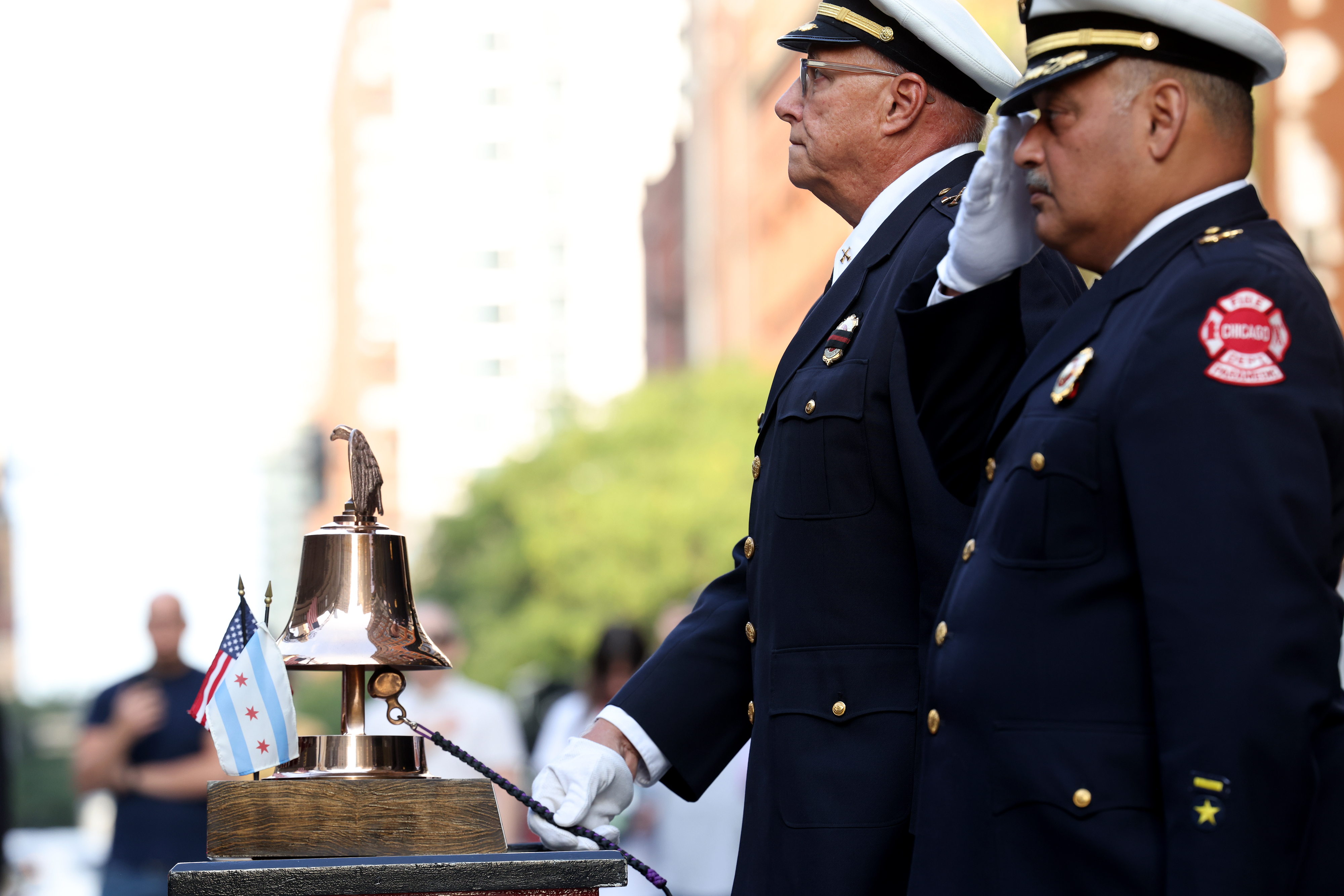 Battalion Chief Jake Jakubec rings the ceremonial bell as Chicago Fire Department and elected officials mark the 23rd anniversary of the 9/11 terrorist attacks during a memorial tribute on Sept. 11, 2024, outside Engine 42 fire station in Chicago. (Antonio Perez/Chicago Tribune)