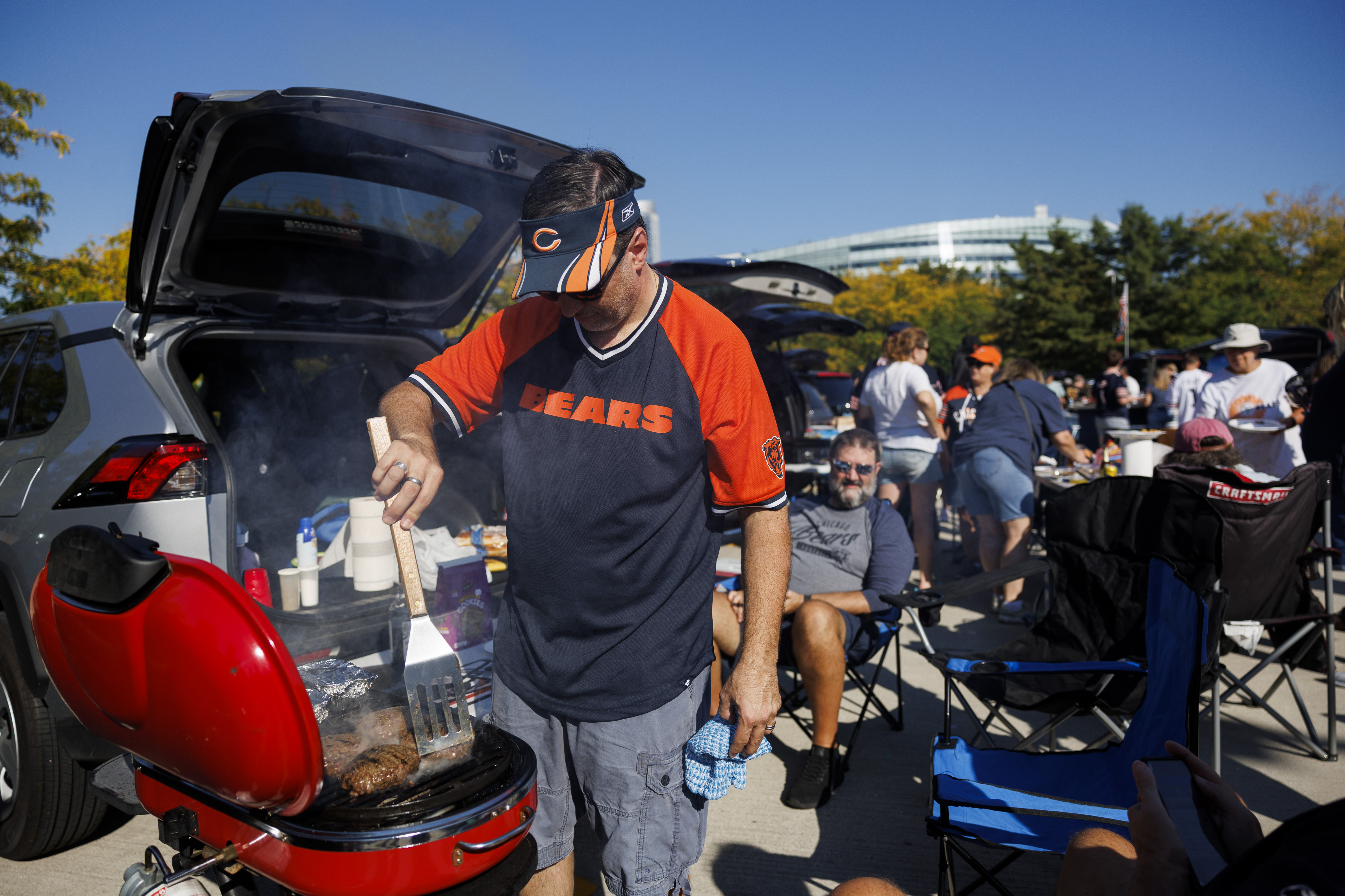 Randy Gohmann grills burgers while tailgating before the Bears play the Broncos on Oct. 1, 2023, at Soldier Field. (Armando L. Sanchez/Chicago Tribune)