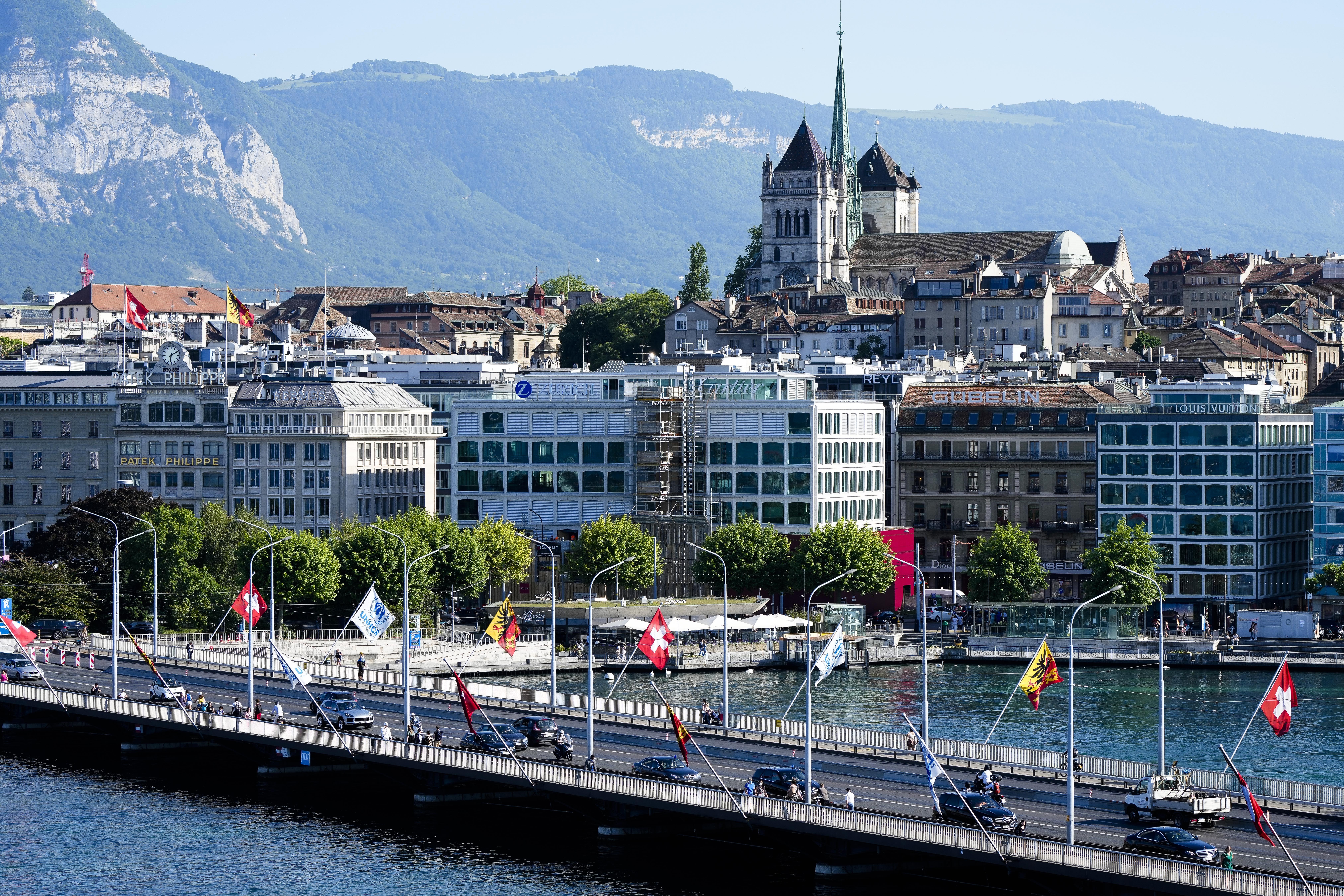 Cars drive on a bridge in front of Old Town backdropped by St. Pierre Cathedral in Geneva, Switzerland in 2021. (Markus Schreiber/AP)