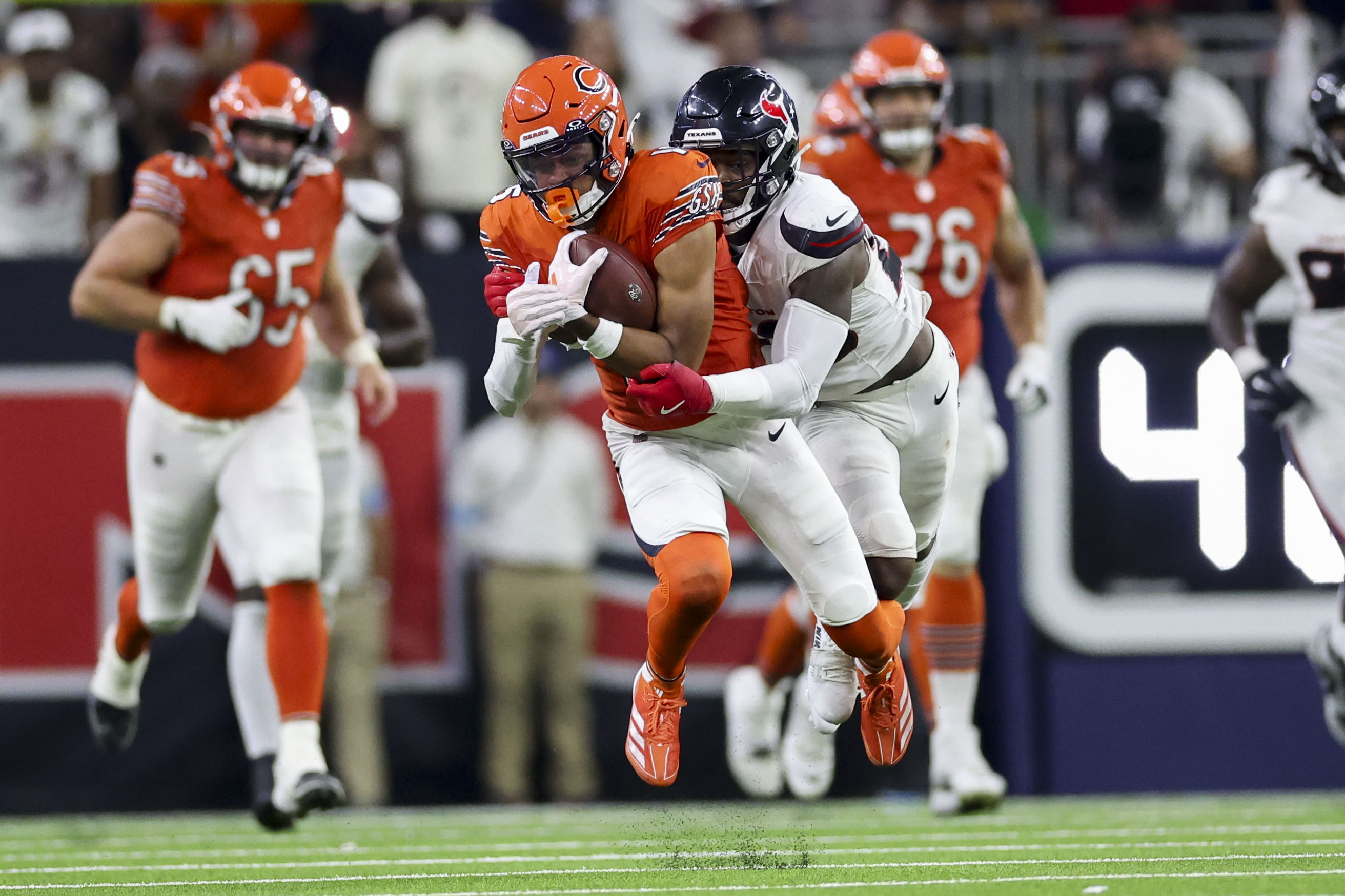 Texans safety Jimmie Ward tackles wide receiver Rome Odunze during the fourth quarter at NRG Stadium on Sept. 15, 2024, in Houston. (Armando L. Sanchez/Chicago Tribune)