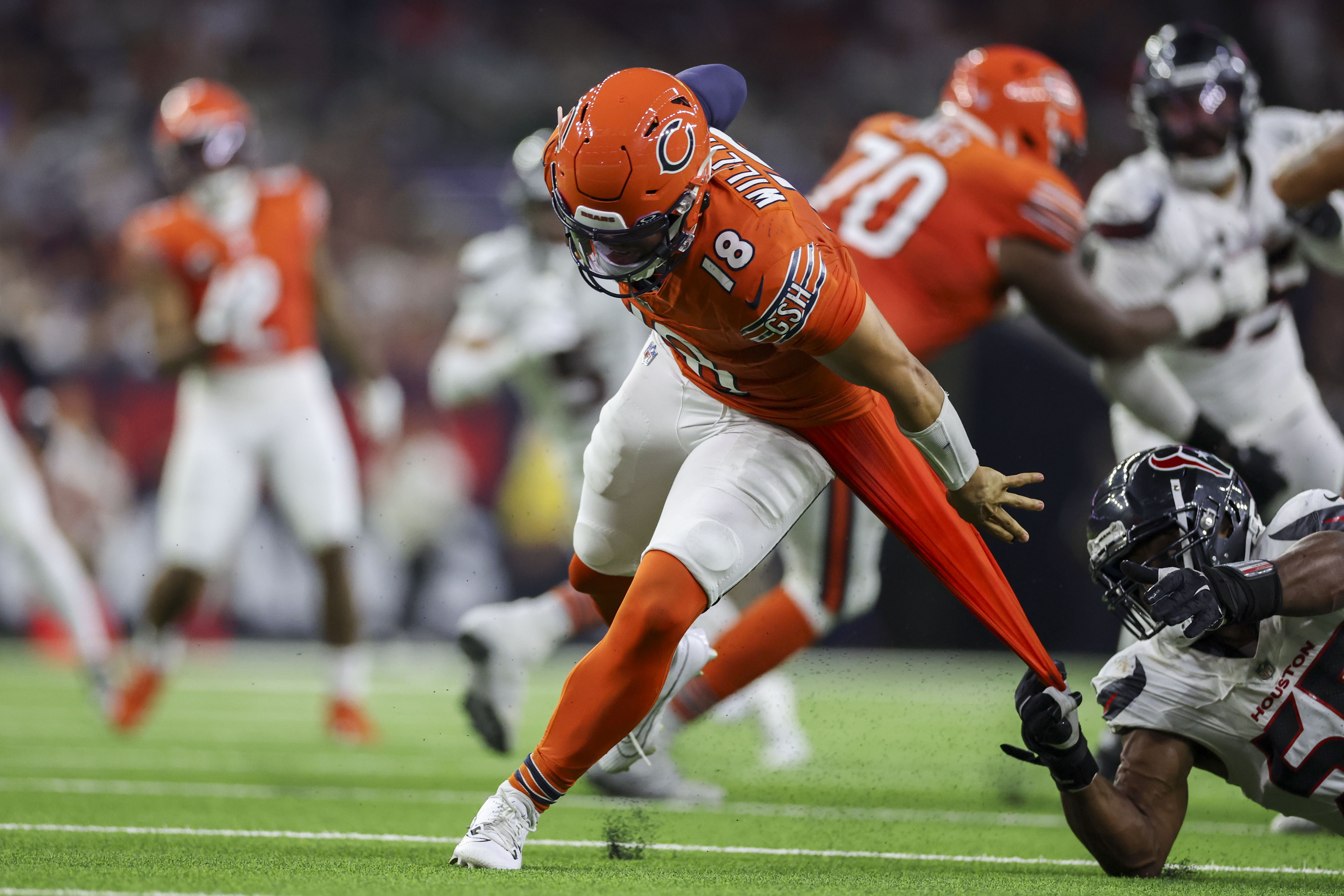 Bears quarterback Caleb Williams breaks a tackle attempt by Texans defensive end Danielle Hunter before throwing an interception during the fourth quarter Sunday, Sept. 15, 2024, in Houston. (Armando L. Sanchez/Chicago Tribune)