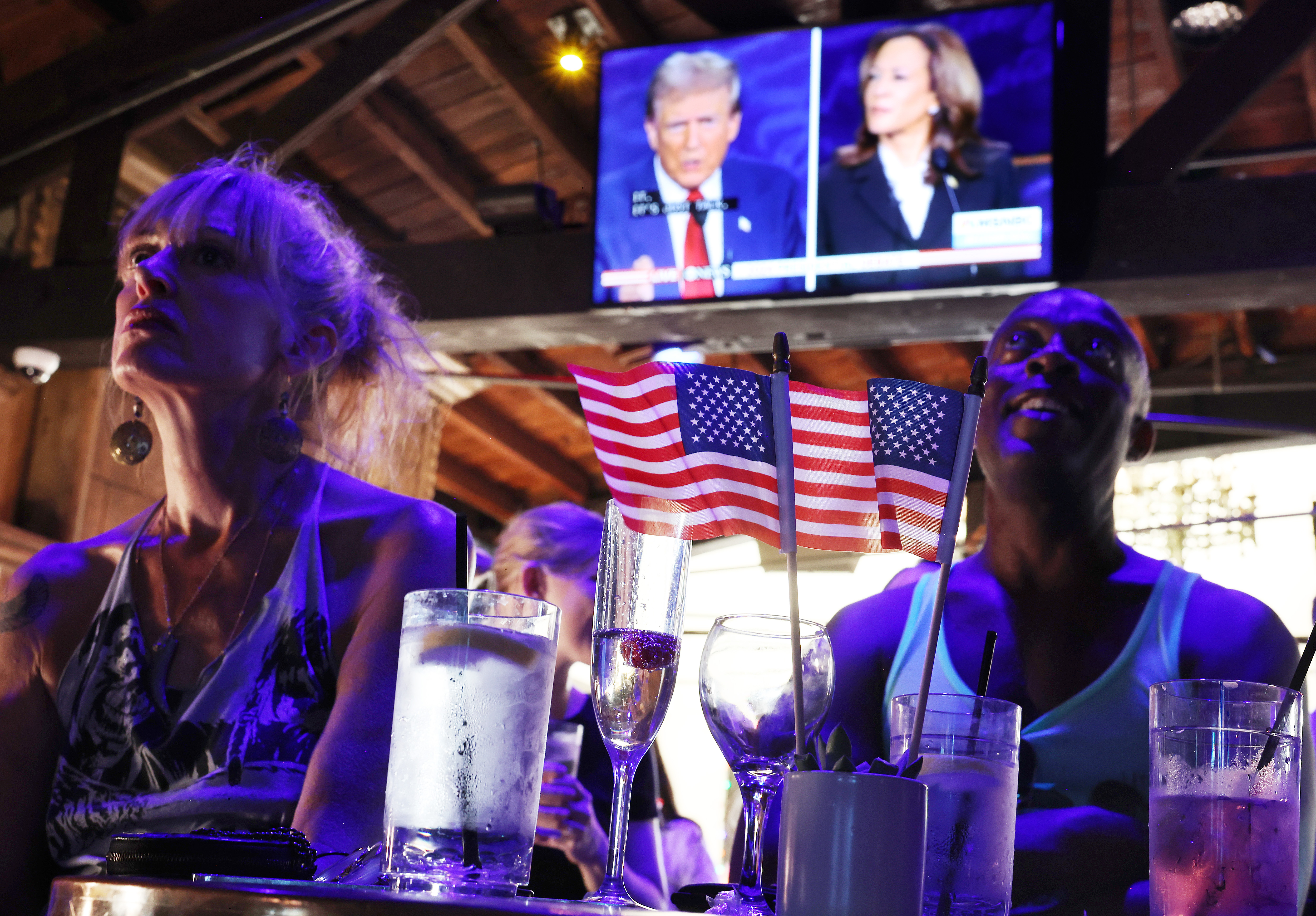 People watch the ABC News presidential debate between Democratic presidential nominee, U.S. Vice President Kamala Harris and Republican presidential nominee, former U.S. President Donald Trump at a debate watch party at The Abbey on Sept. 10, 2024, in West Hollywood, California. (Mario Tama/Getty)