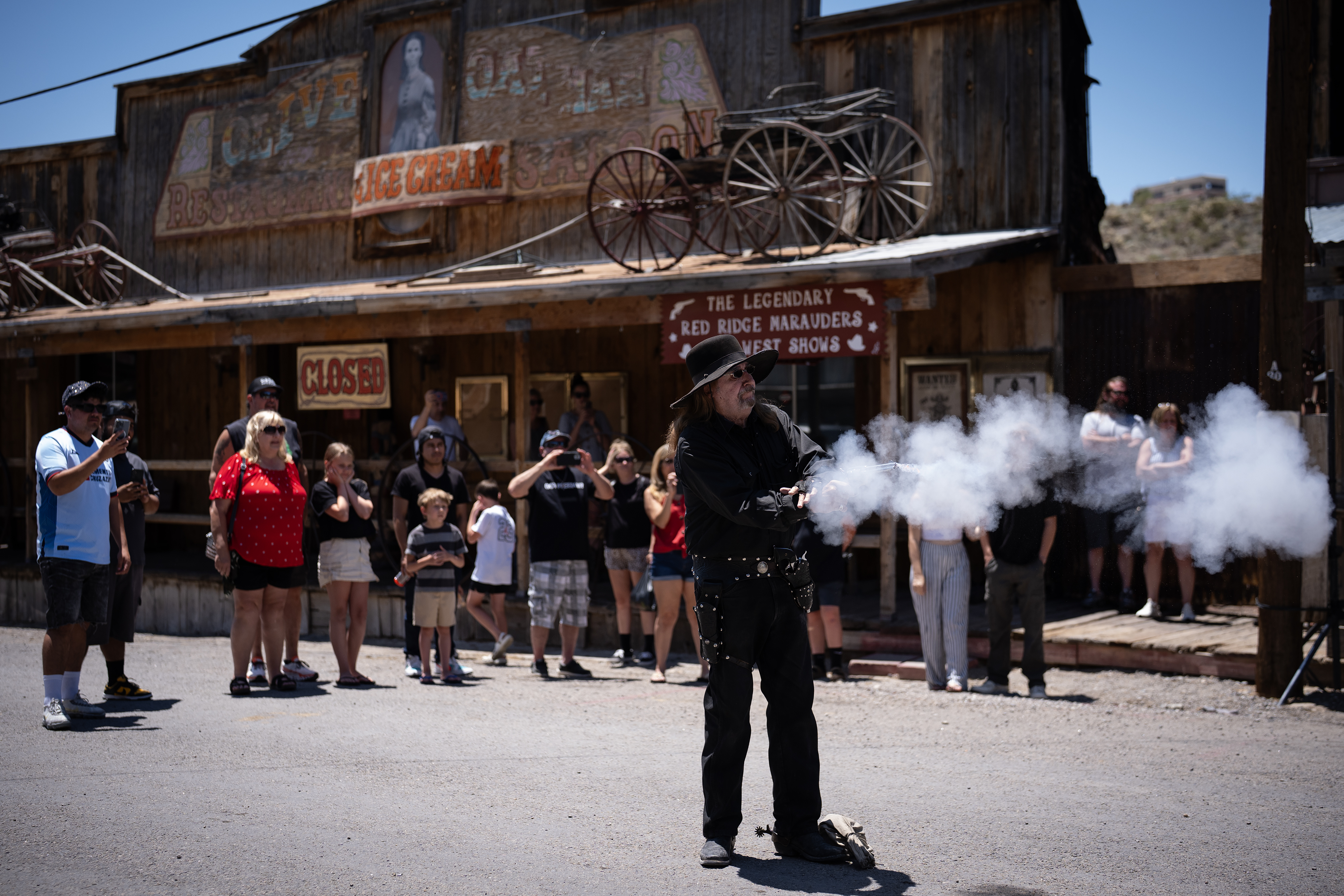 Outlaw Willie, also known as Rod Hall, 80, stages a gun fight on Route 66 in Oatman, Arizona, June 4, 2025. (E. Jason Wambsgans/Chicago Tribune)