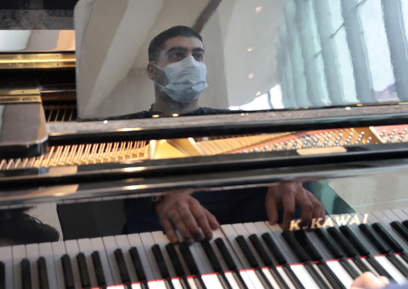 Nurse Guido Calcagno plays the piano for patients, guests and staff in the lobby at Advocate Good Shepherd Hospital in Barrington on March 21, 2023. (Antonio Perez/Chicago Tribune/TNS)
