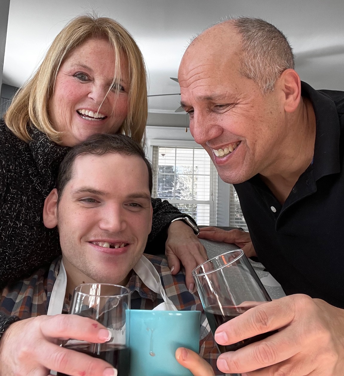 Stefan Burn, who has Angelman syndrome, with his parents, David and Roberta Burn. (Courtesy of David Burn)