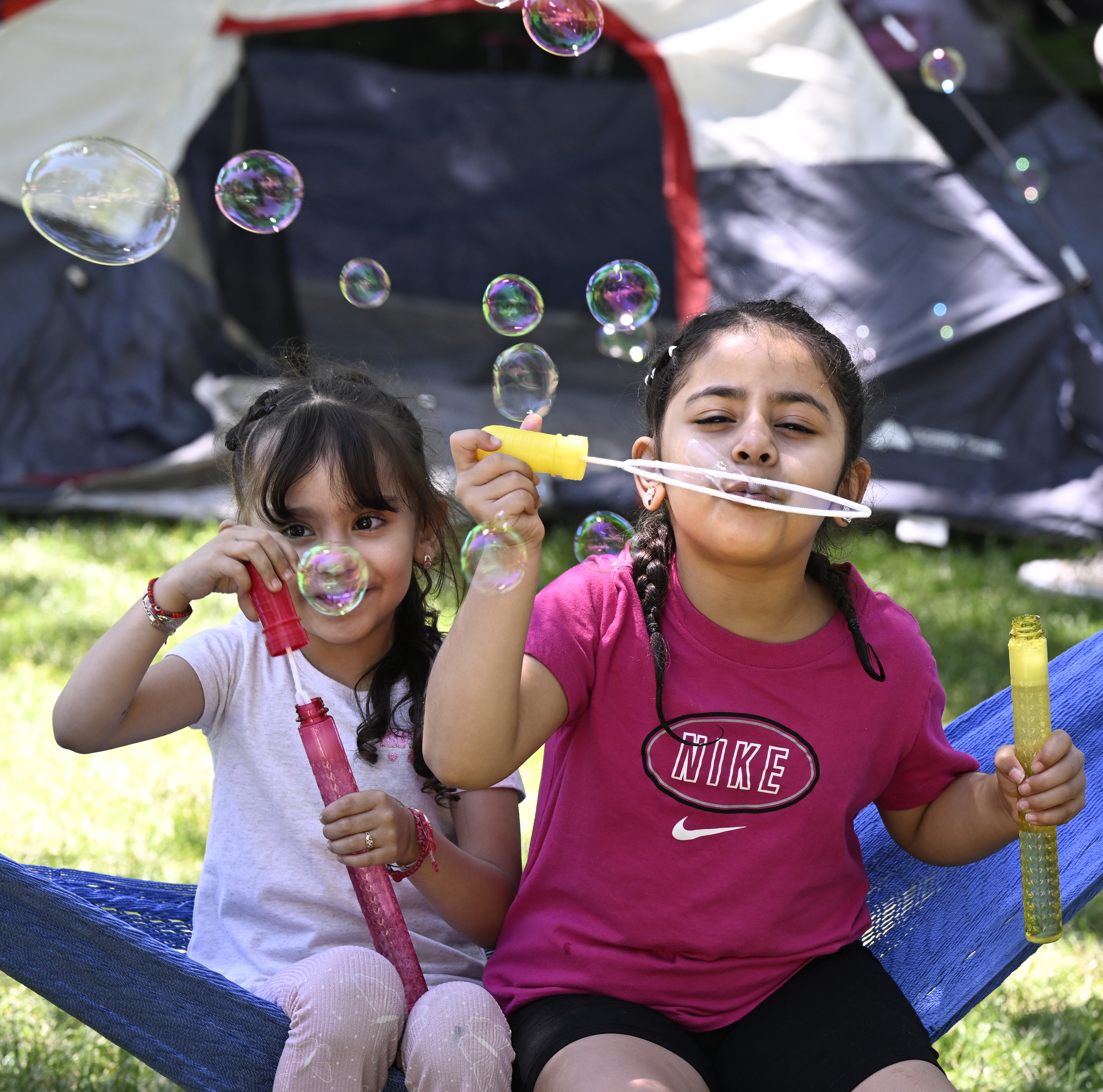 Dora Salgado, left, and Ivanna Miranda, blow bubbles at Eben G. Fine Park, 101 Arapahoe Ave. on Thursday.(Cliff Grassmick/Staff Photographer)