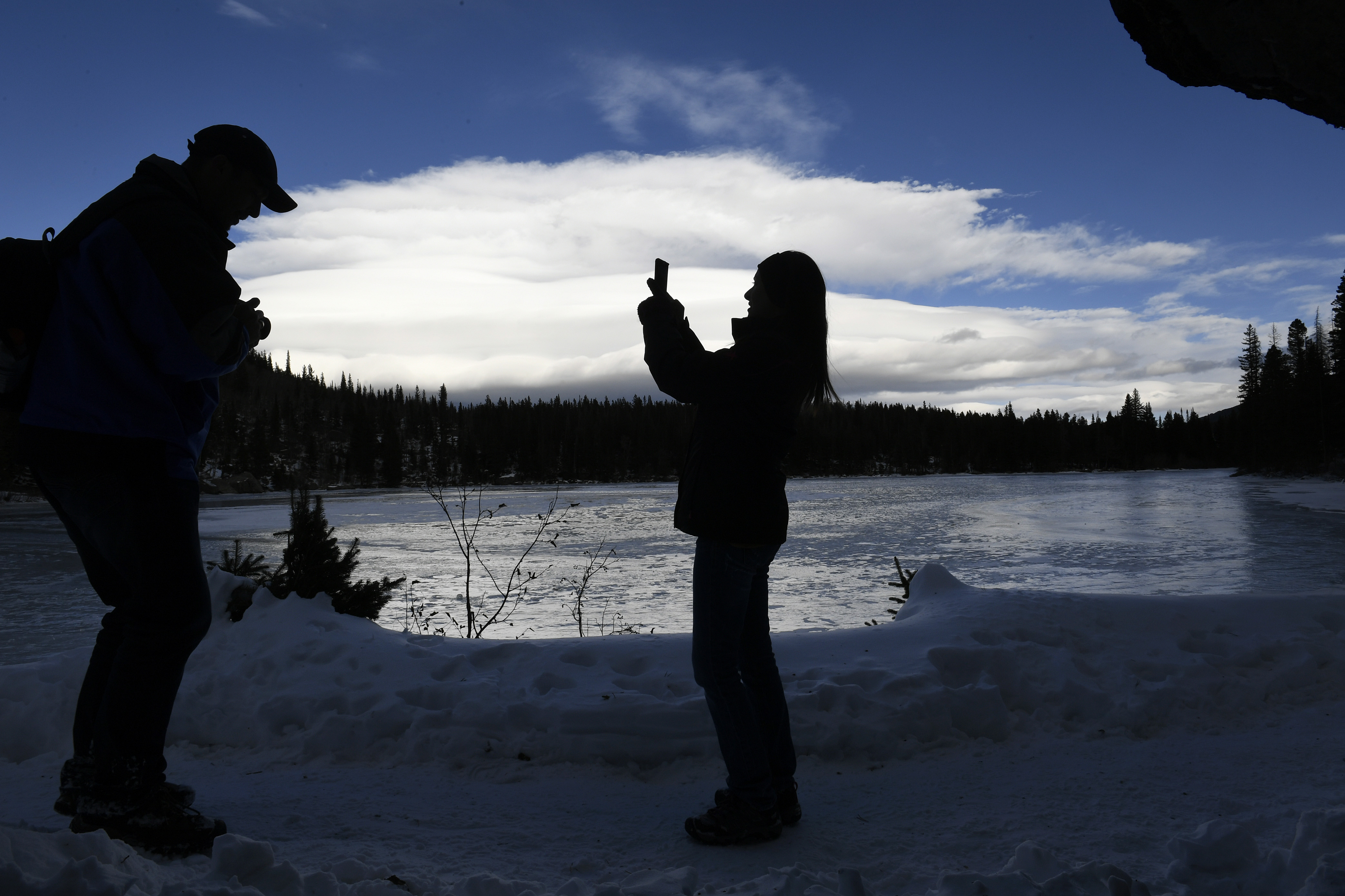 ROCKY MOUNTAIN NATIONAL PARK, CO - NOVEMBER 3: Alysia Fostek, right, and her husband Chris, left, take photos at the scenery around Bear Lake on November 3, 2019 in Rocky Mountain National Park, Colorado. Bear Lake is an easy hike from the parking lot with a multitude of longer hikes in the area. The couple were visiting the park from Collegeville, Pennsylvania. (Photo by Helen H. Richardson/The Denver Post)