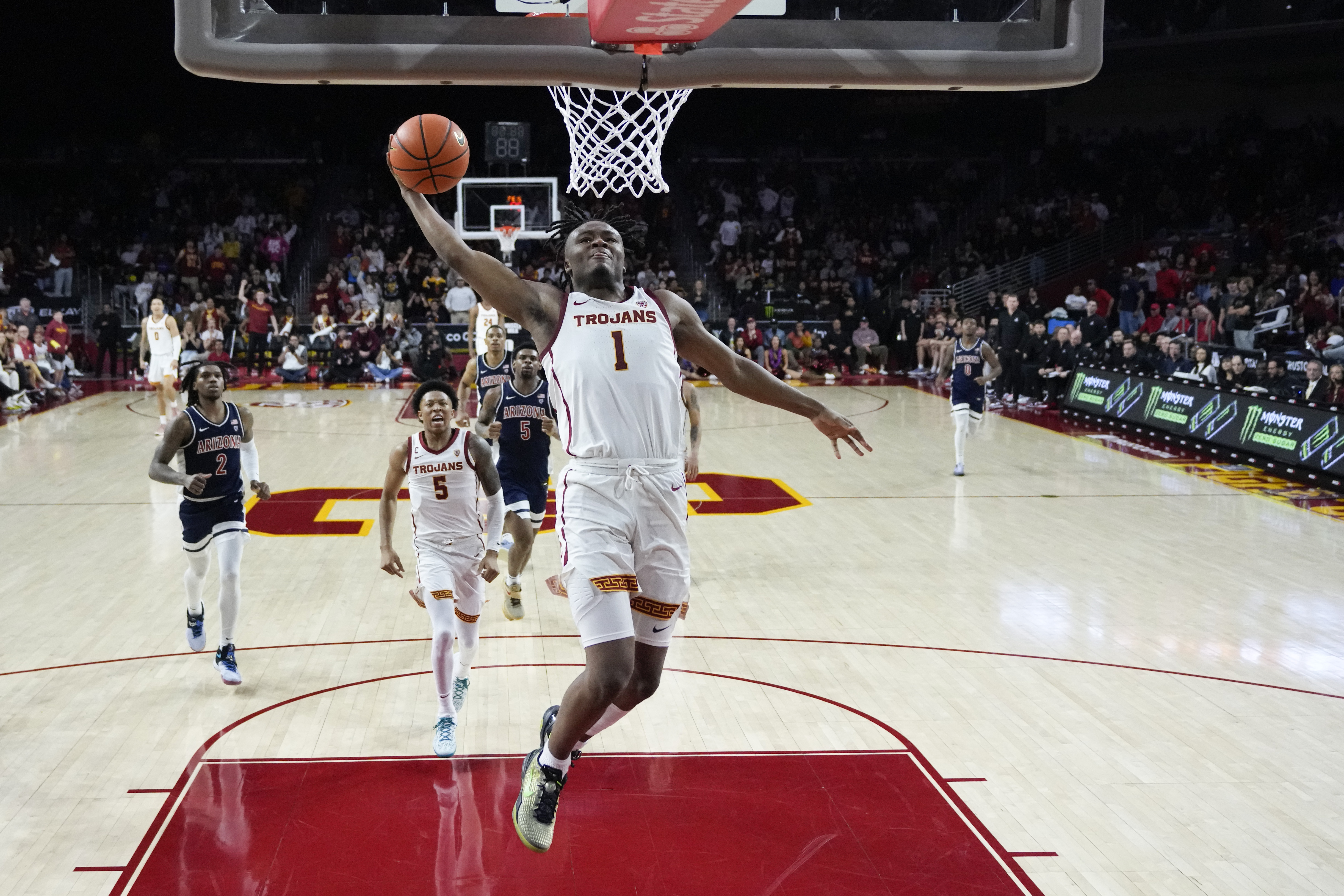 Southern California guard Isaiah Collier (1) scores on a breakaway dunk against Arizona during the second half of an NCAA college basketball game Saturday, March 9, 2024, in Los Angeles. (AP Photo/Marcio Jose Sanchez)