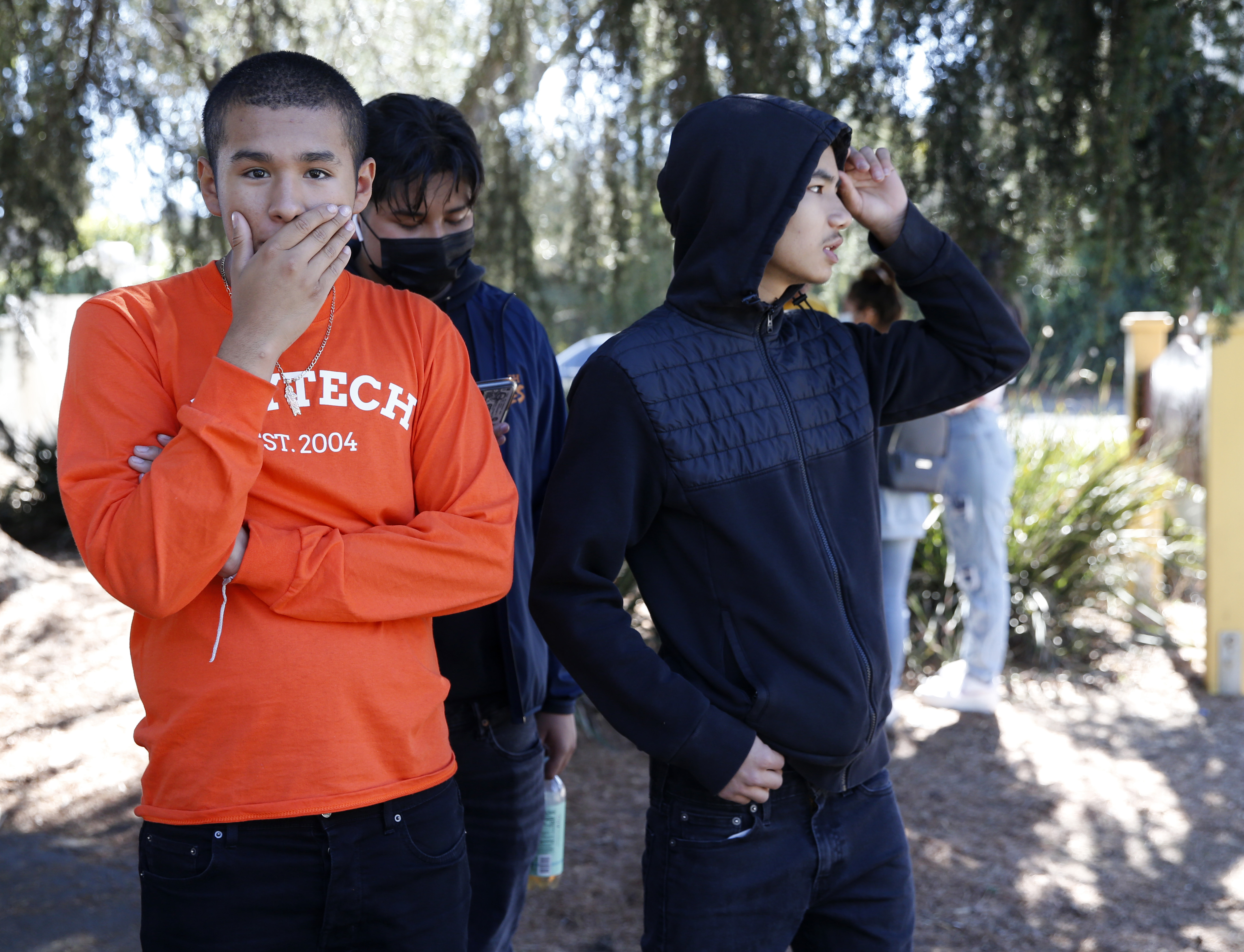 OAKLAND, CALIFORNIA - SEPTEMBER 28: Students gather at St. Cuthbert's Episcopal Church on Mountain Boulevard and Keller Avenue as law enforcement officers from several agencies respond after at least six adults were shot at the Bay Area Technology School complex in East Oakland, Calif., on Wednesday, Sept. 28, 2022. (Jane Tyska/Bay Area News Group)
