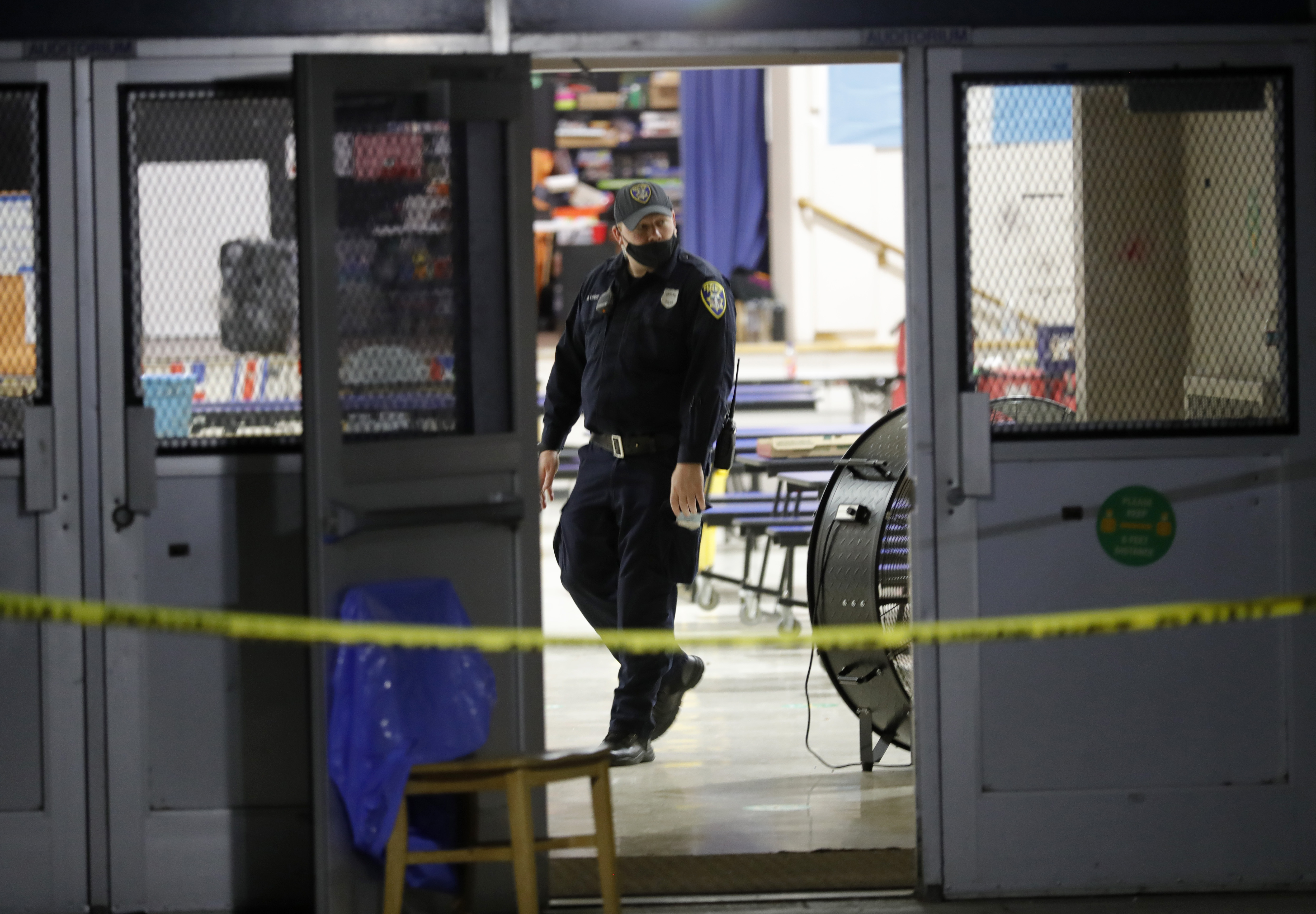 OAKLAND, CALIFORNIA - SEPTEMBER 28: An Oakland police officer investigates a mass shooting at the King Estates Complex school campus on Fontaine Street in East Oakland, Calif., on Wednesday, Sept. 28, 2022. Six adult victims were transported to local hospitals and two remain in critical condition. (Jane Tyska/Bay Area News Group)