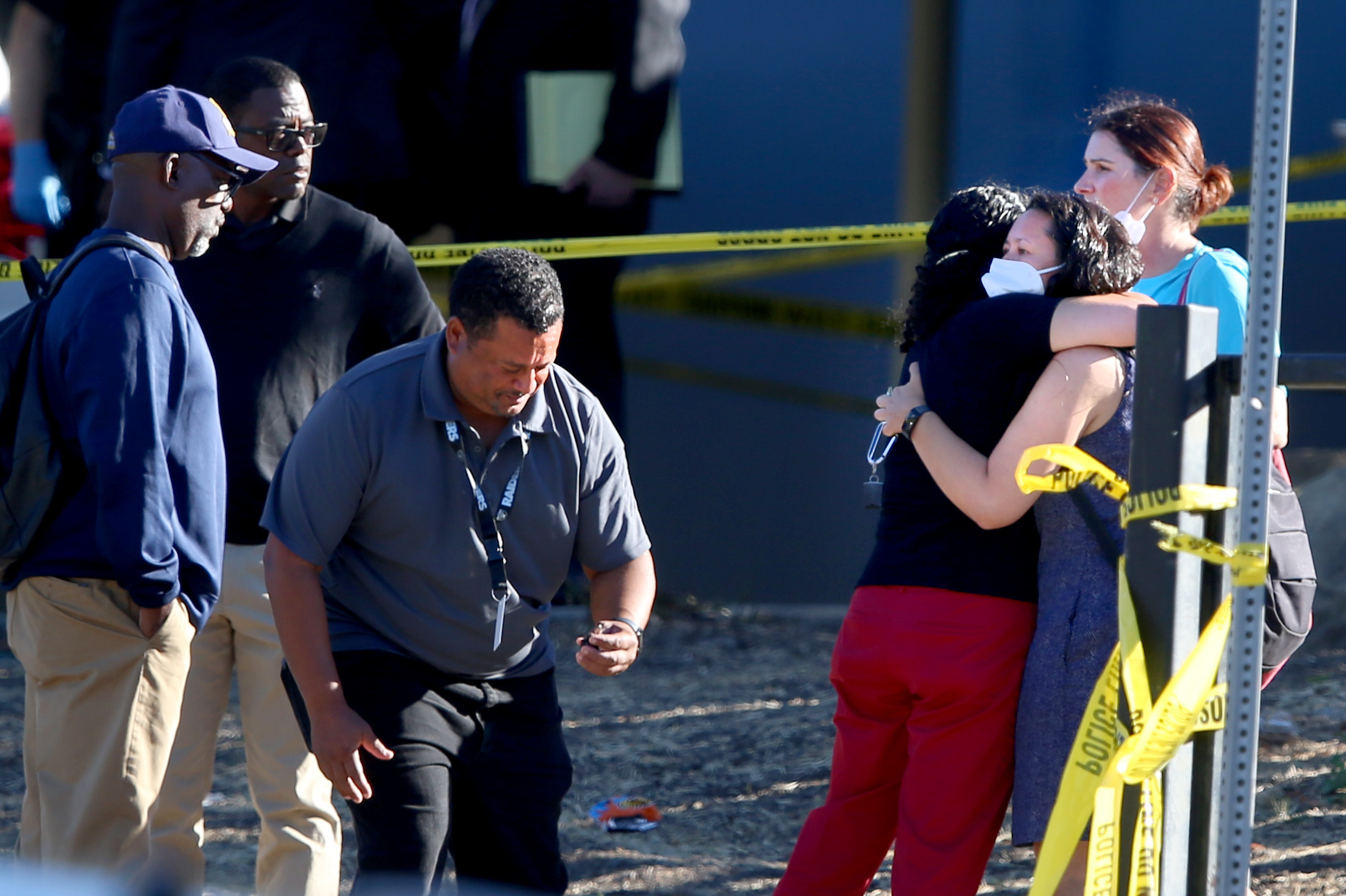 OAKLAND, CALIFORNIA - SEPTEMBER 28: Two women hug each other after faculty and staff return to the complex of schools for their belongings were six adults were shot in Oakland, Calif.,on Wednesday, Sept. 28, 2022. (Ray Chavez/Bay Area News Group)
