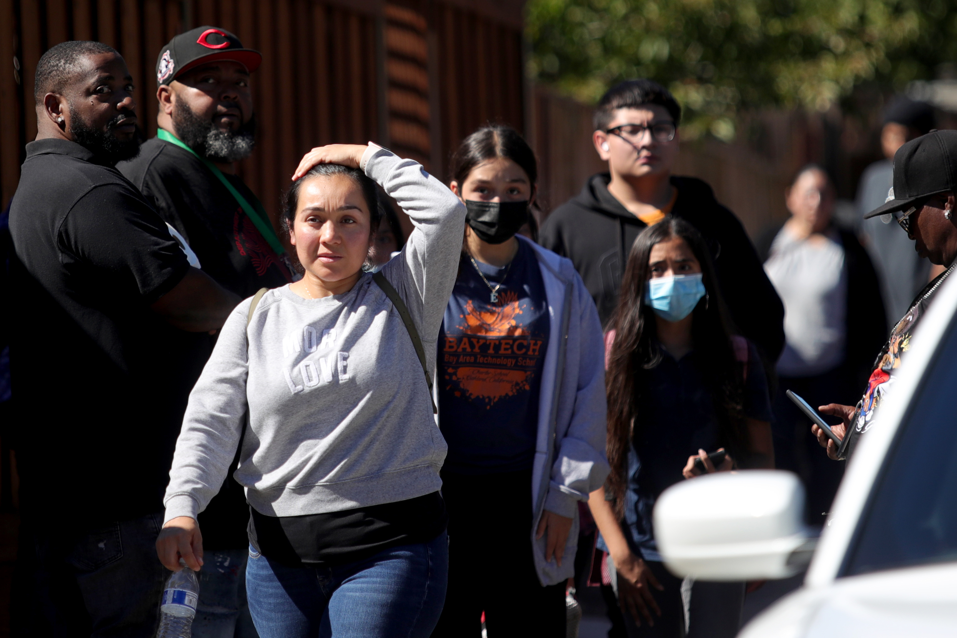 OAKLAND, CALIFORNIA - SEPTEMBER 28: Students and adults walk along Fontaine Street in Oakland, Calif., after a multiple people were shot in a complex of schools on Wednesday, Sept. 28, 2022. Ray Chavez/Bay Area News Group)