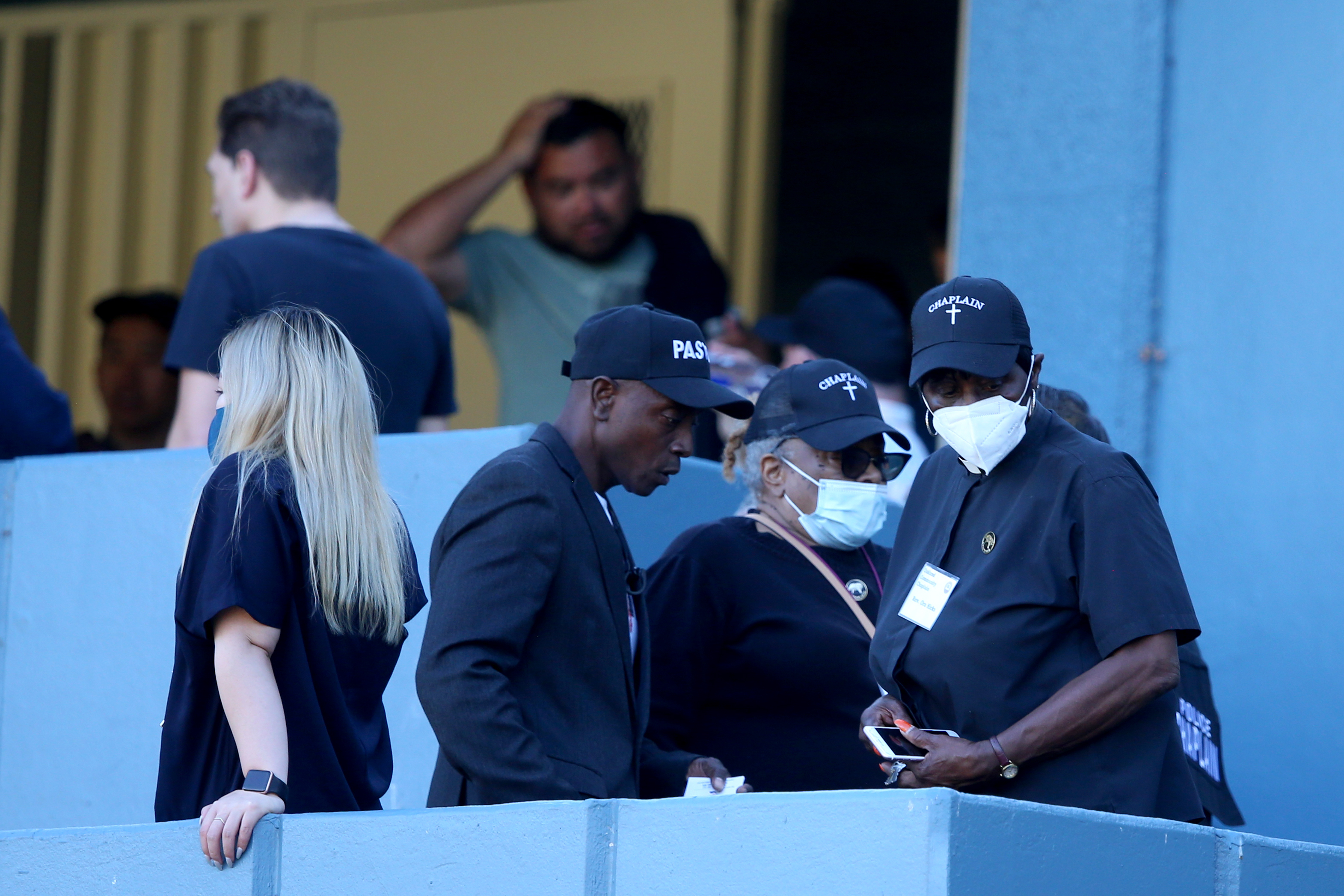 OAKLAND, CALIFORNIA - SEPTEMBER 28: Chaplains stand on the stairs to the entrance at one the King Estate schools after faculty and staff return for their belongings were six adults were shot on Fontaine Street in Oakland, Calif.,on Wednesday, Sept. 28, 2022. (Ray Chavez/Bay Area News Group)