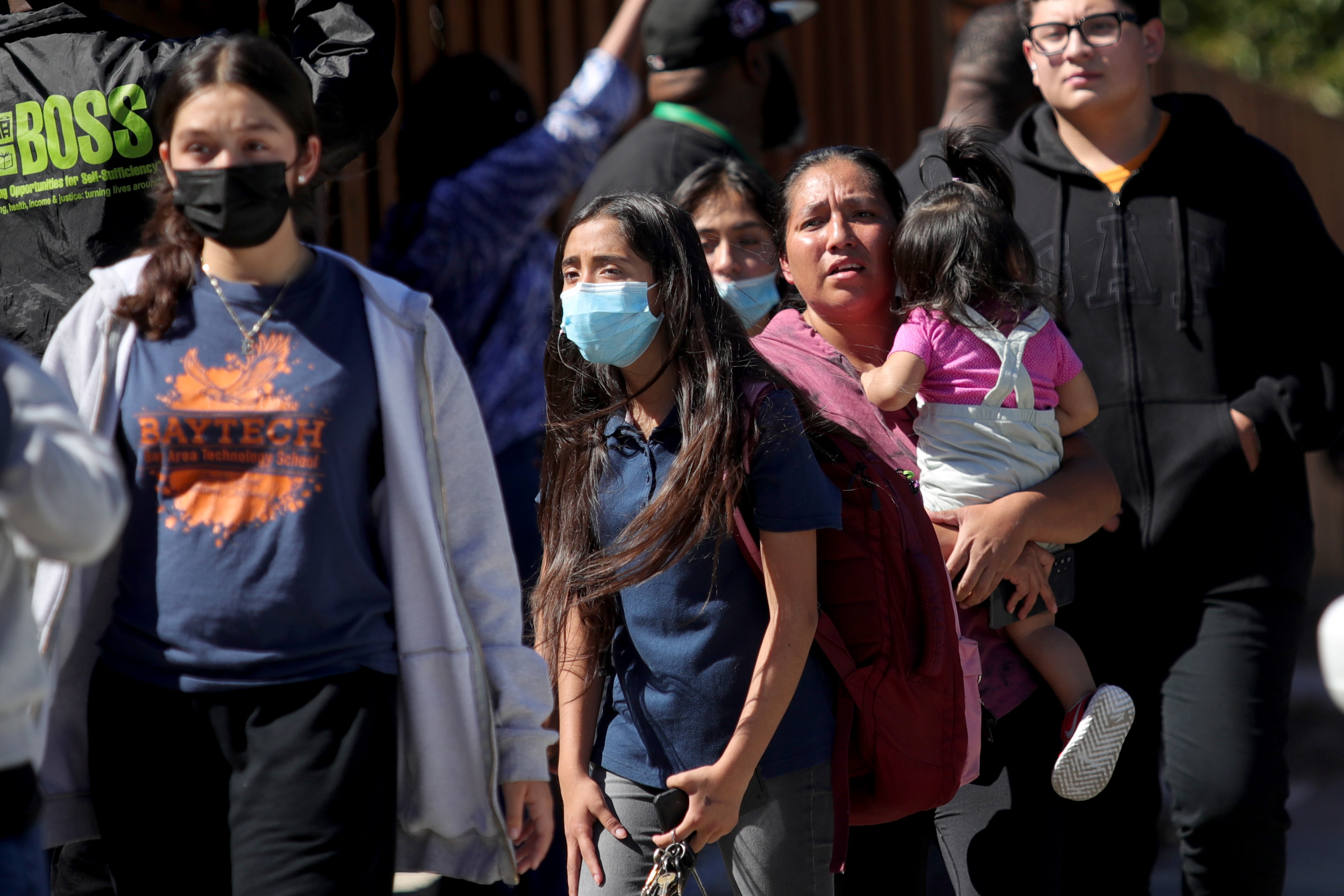 OAKLAND, CALIFORNIA - SEPTEMBER 28: Students and adults walk along Fontaine Street in Oakland, Calif., after a multiple people were shot in a complex of schools on Wednesday, Sept. 28, 2022. Ray Chavez/Bay Area News Group)