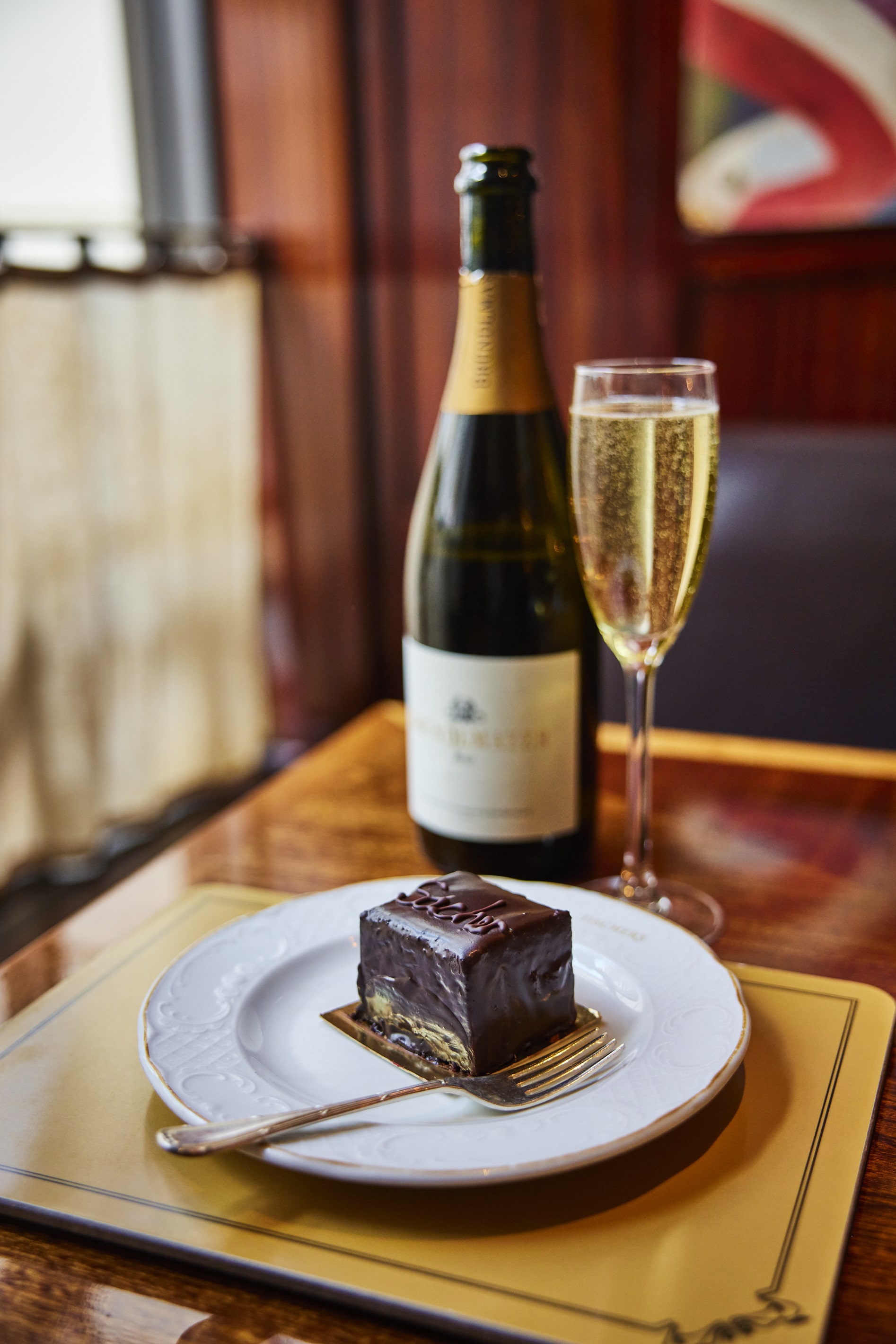 Traditional Sacher cake with glass of champagne