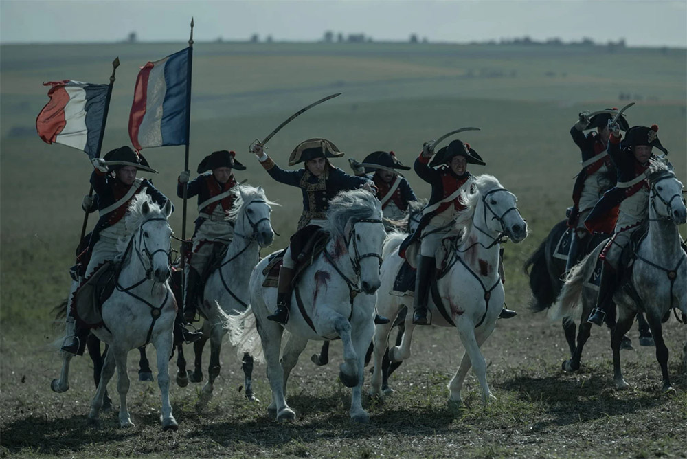 Napoleon on his horse weilding his sword surrounded by his army