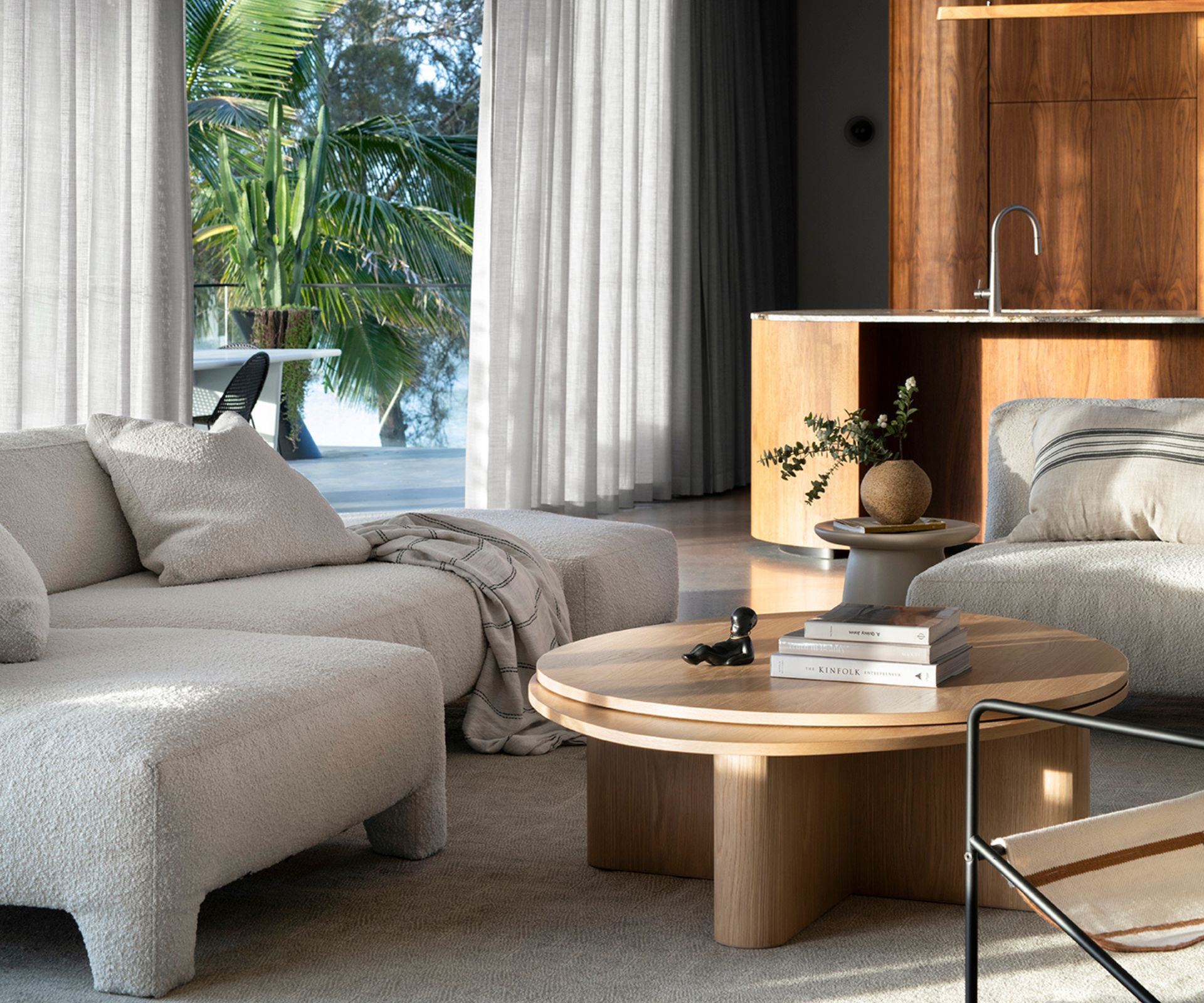 A contemporary living room showing a modern oak round coffee table