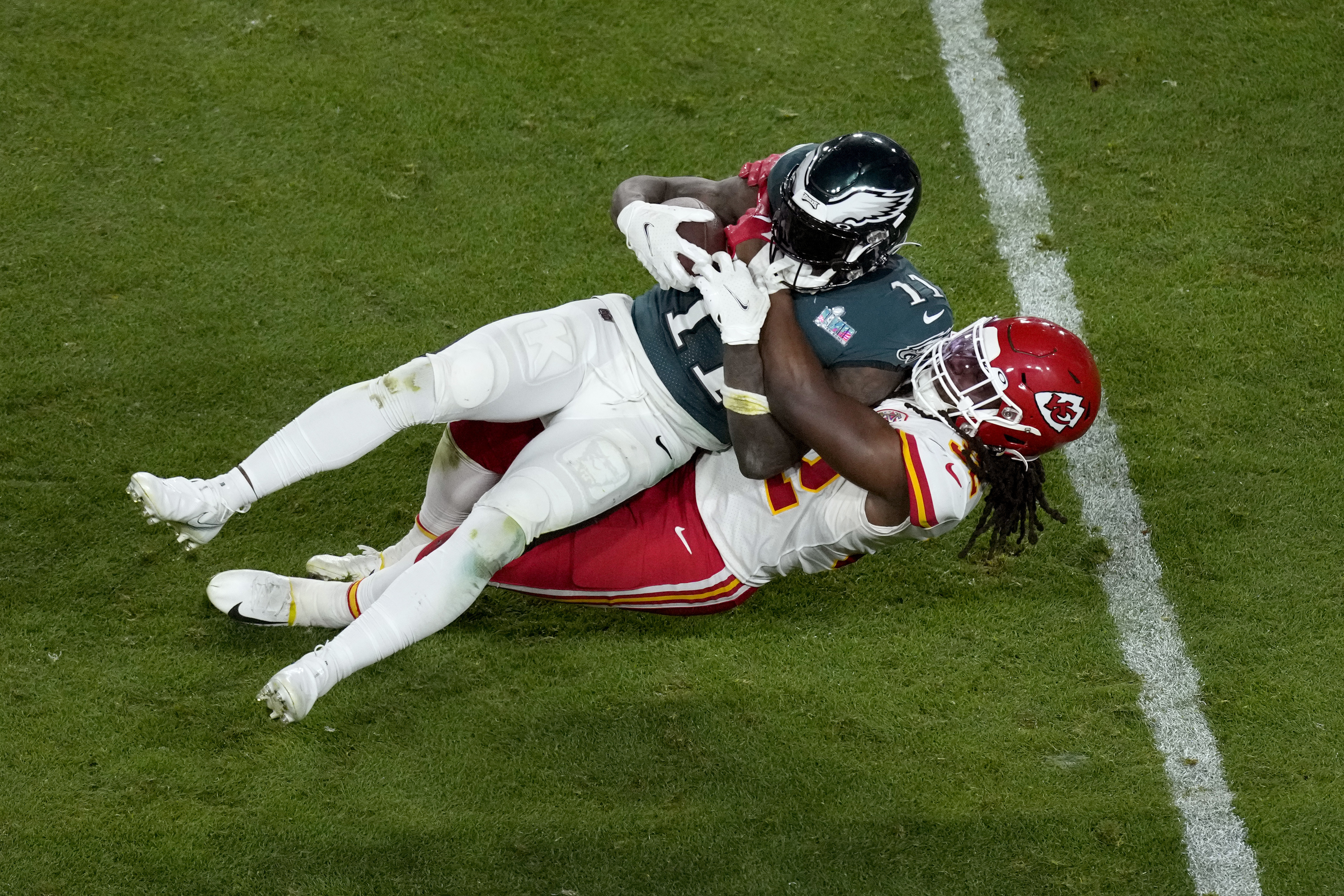 Philadelphia Eagles wide receiver A.J. Brown (11) is tackled by Kansas City Chiefs linebacker Nick Bolton during the second half of the NFL Super Bowl 57 football game, Sunday, Feb. 12, 2023, in Glendale, Ariz. (AP Photo/Charlie Riedel)