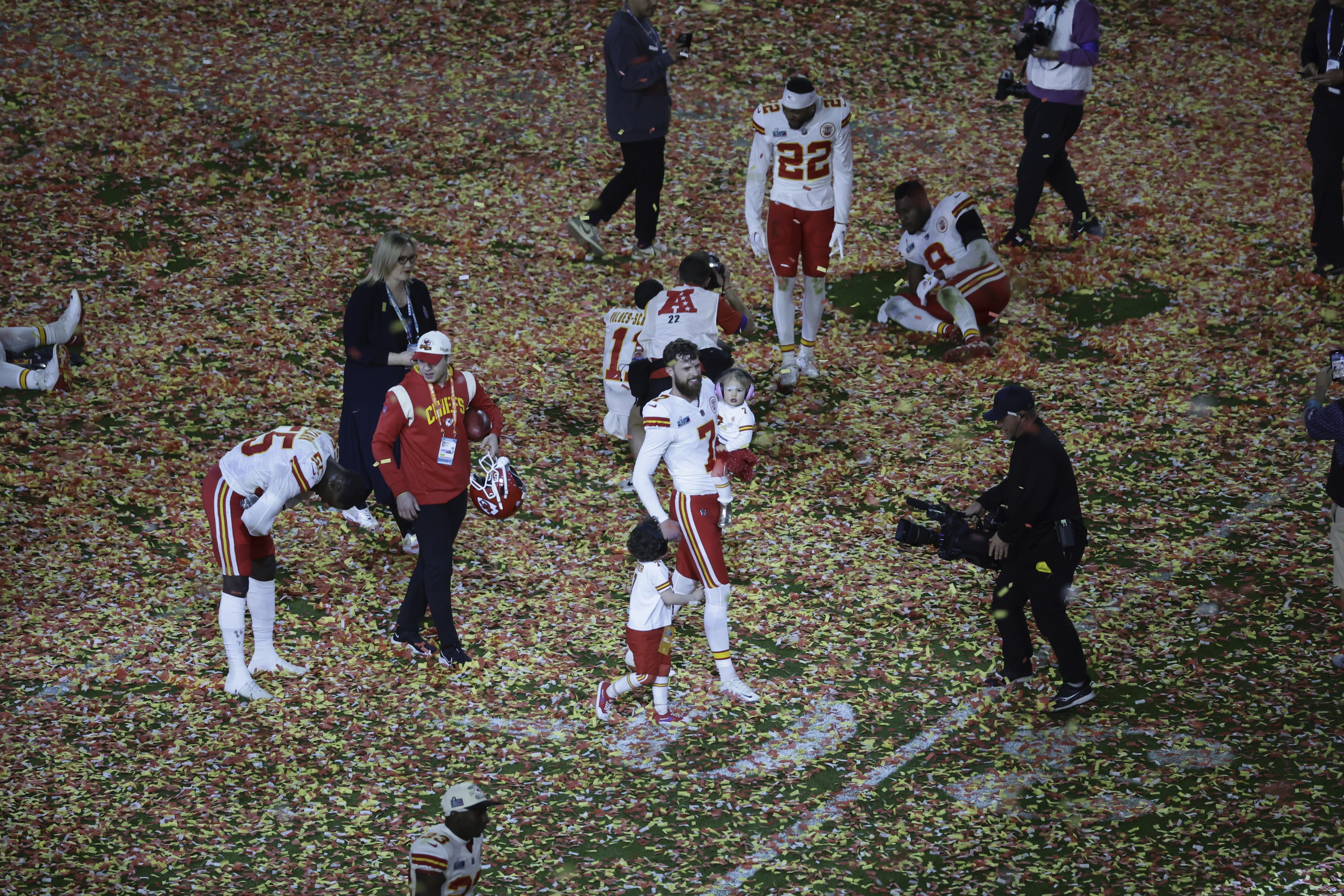 Kansas City Chiefs place kicker Harrison Butker (7) walks on field with his kids after winning the NFL Super Bowl 57 football game, Sunday, Feb. 12, 2023, in Glendale, Ariz. (AP Photo/Adam Hunger)