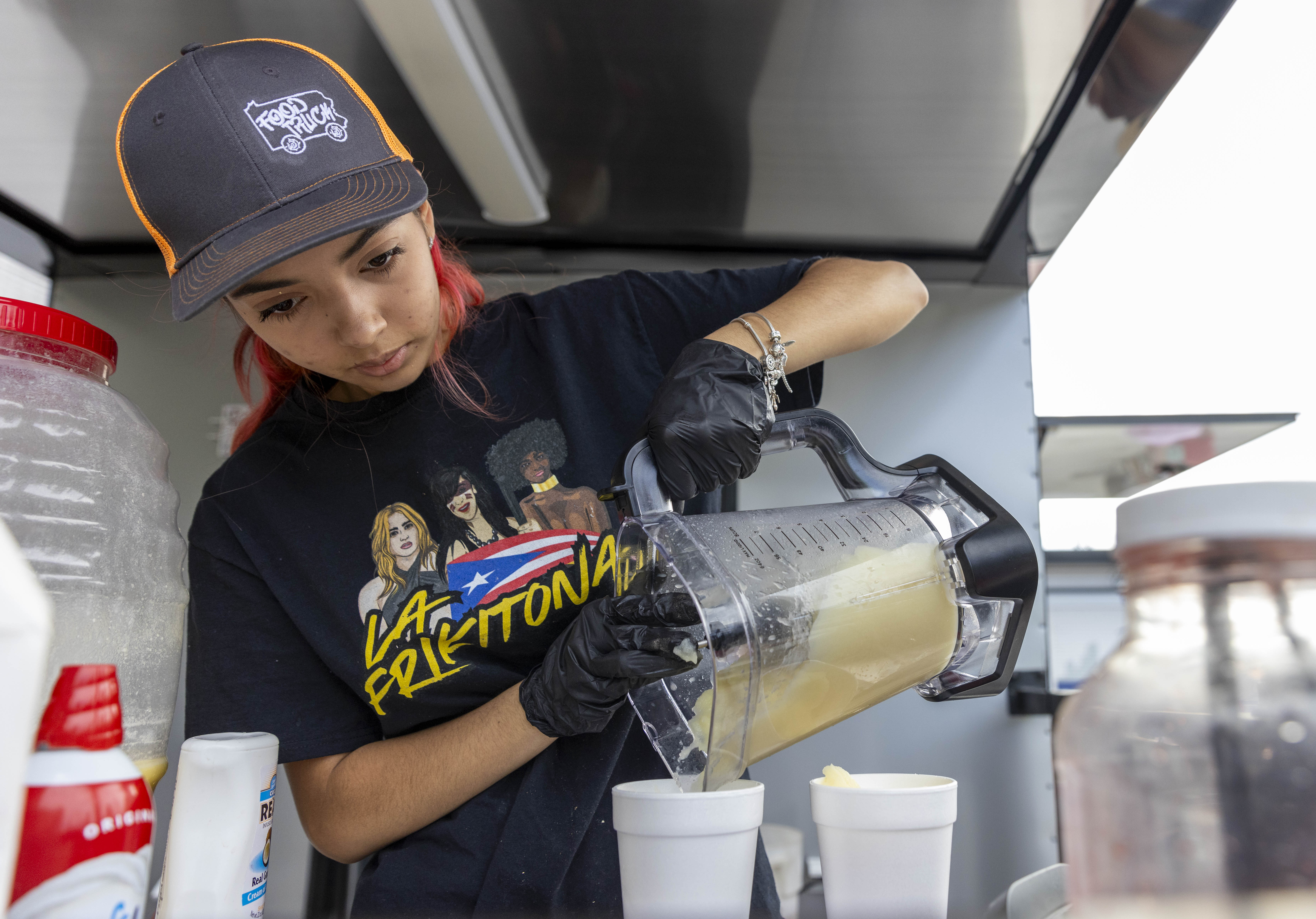 A vendor prepares food for visitors to the 13th annual ¡Sabor! Latin Festival on Friday, June 28, 2024, at SteelStacks in Bethlehem. The festival is a celebration of Latin heritage including music, food and family fun. (Emma Reed/The Morning Call)