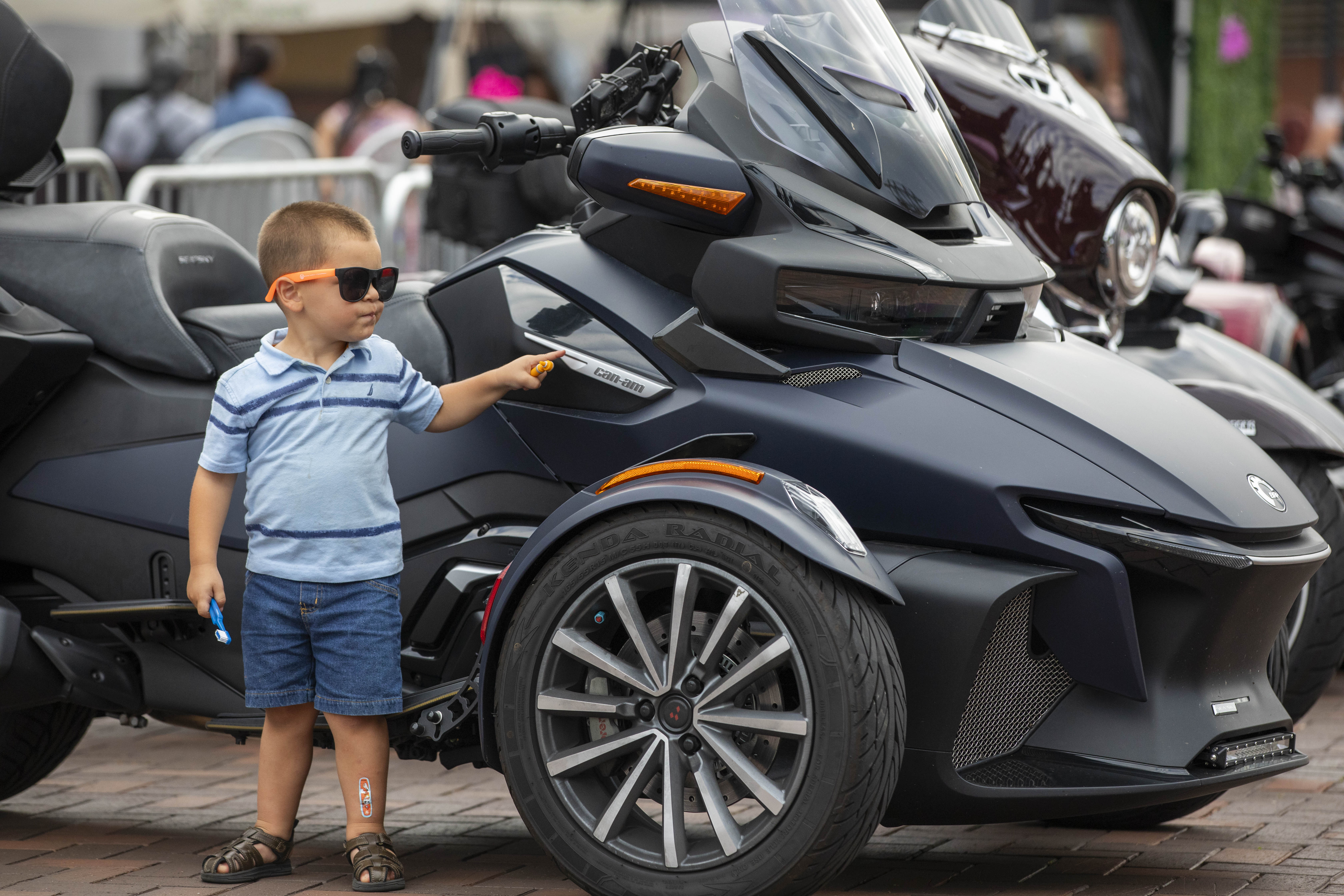 Noah Mourani looks at motorcycle Friday, June 28, 2024, during the 13th annual ¡Sabor! Latin Festival at SteelStacks in Bethlehem. The festival is a celebration of Latin heritage including music, food and family fun. (Emma Reed/The Morning Call)