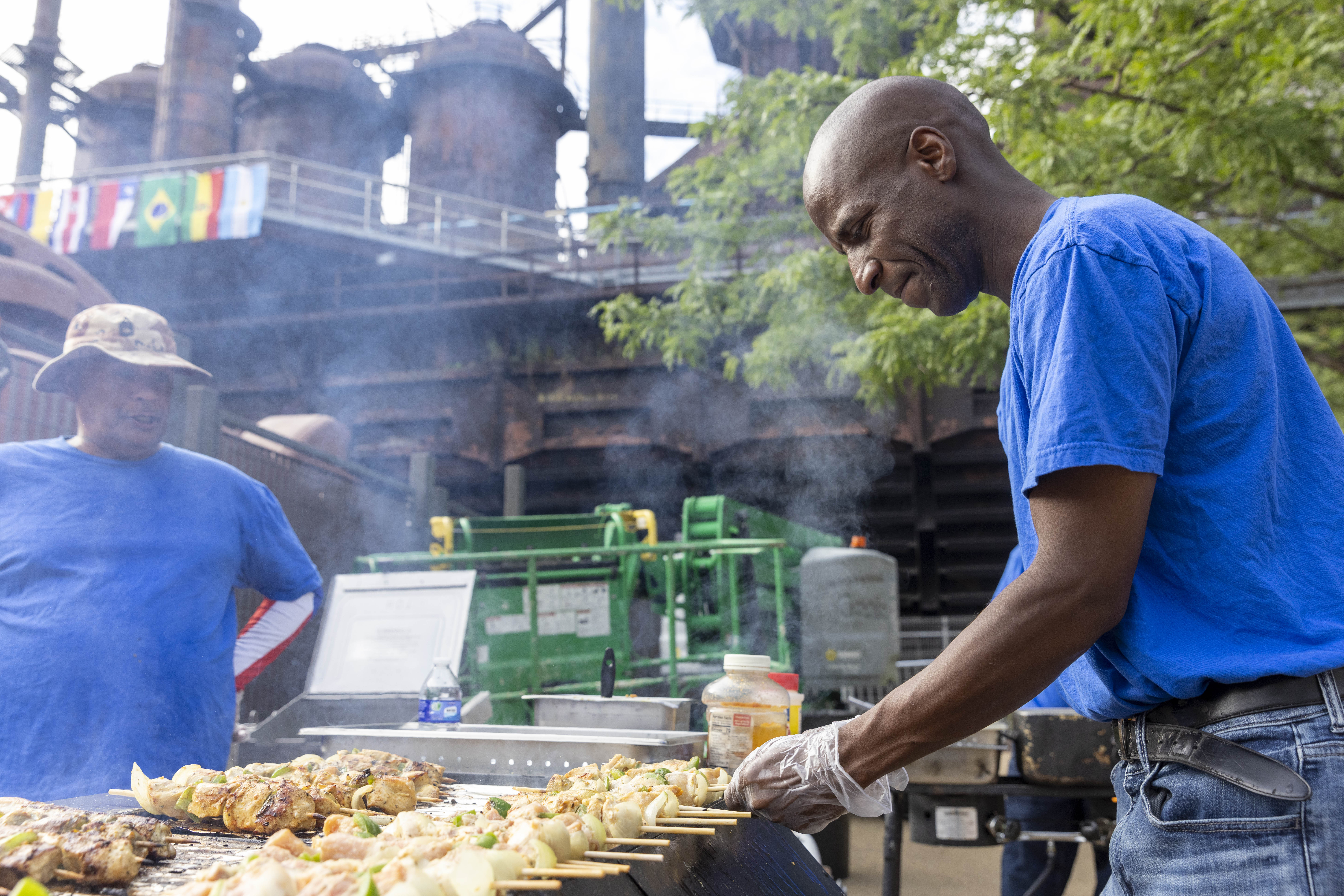 A vendor prepares food for visitors to the 13th annual ¡Sabor! Latin Festival on Friday, June 28, 2024, at SteelStacks in Bethlehem. The festival is a celebration of Latin heritage including music, food and family fun. (Emma Reed/The Morning Call)