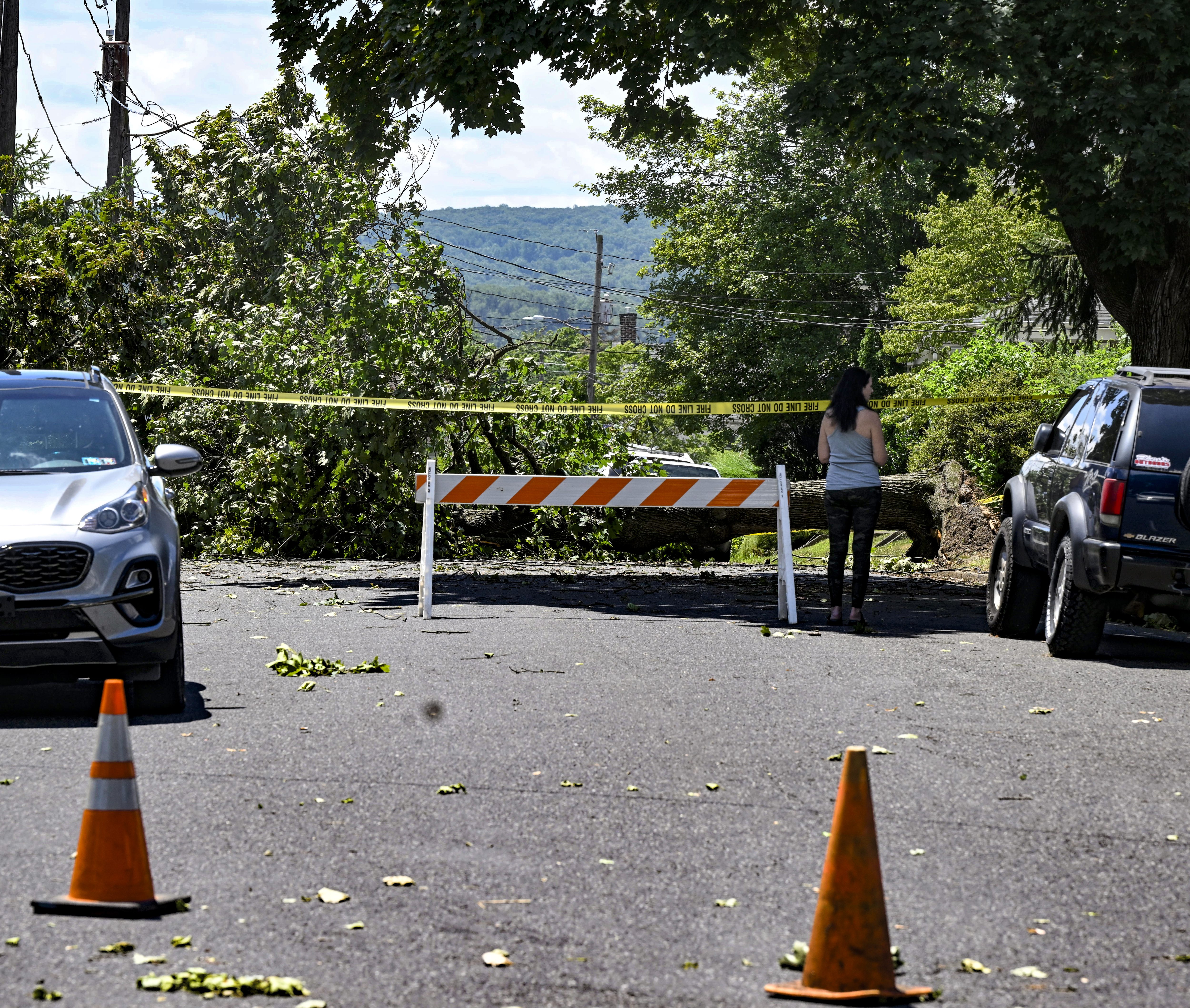 A tree is down and a part of 3rd Avenue is closed Thursday, June 27, 2024, in Hellertown after a severe thunderstorm with nearly 60 mph wind gusts ripped through the Lehigh Valley the night before. (Monica Cabrera/The Morning Call)