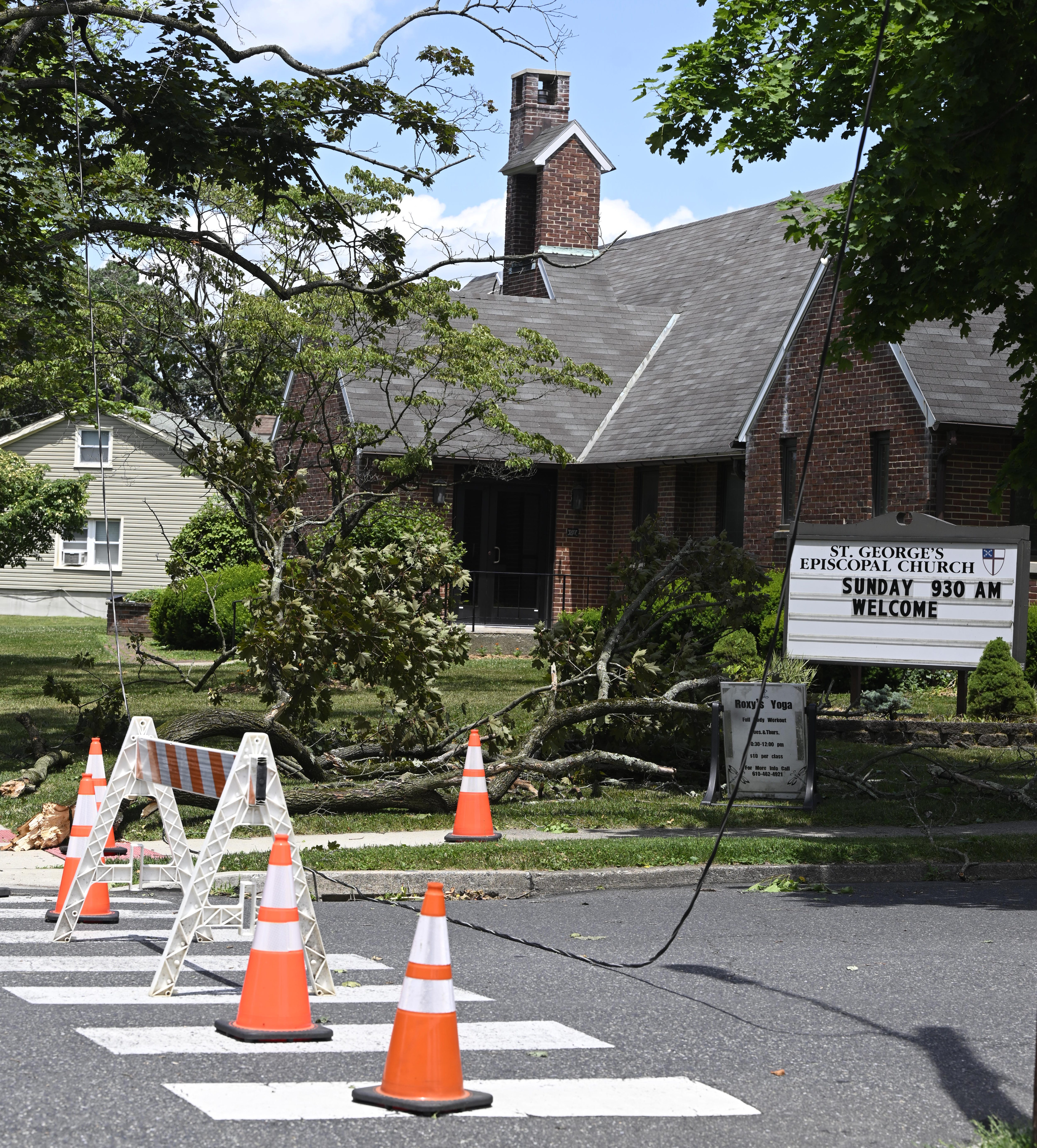 A power line is still down and Delaware Avenue is closed near St. George's Episcopal Church Thursday, June 27, 2024, in Hellertown after a severe thunderstorm with nearly 60 mph wind gusts ripped through the Lehigh Valley the night before. (Monica Cabrera/Special to The Morning Call)