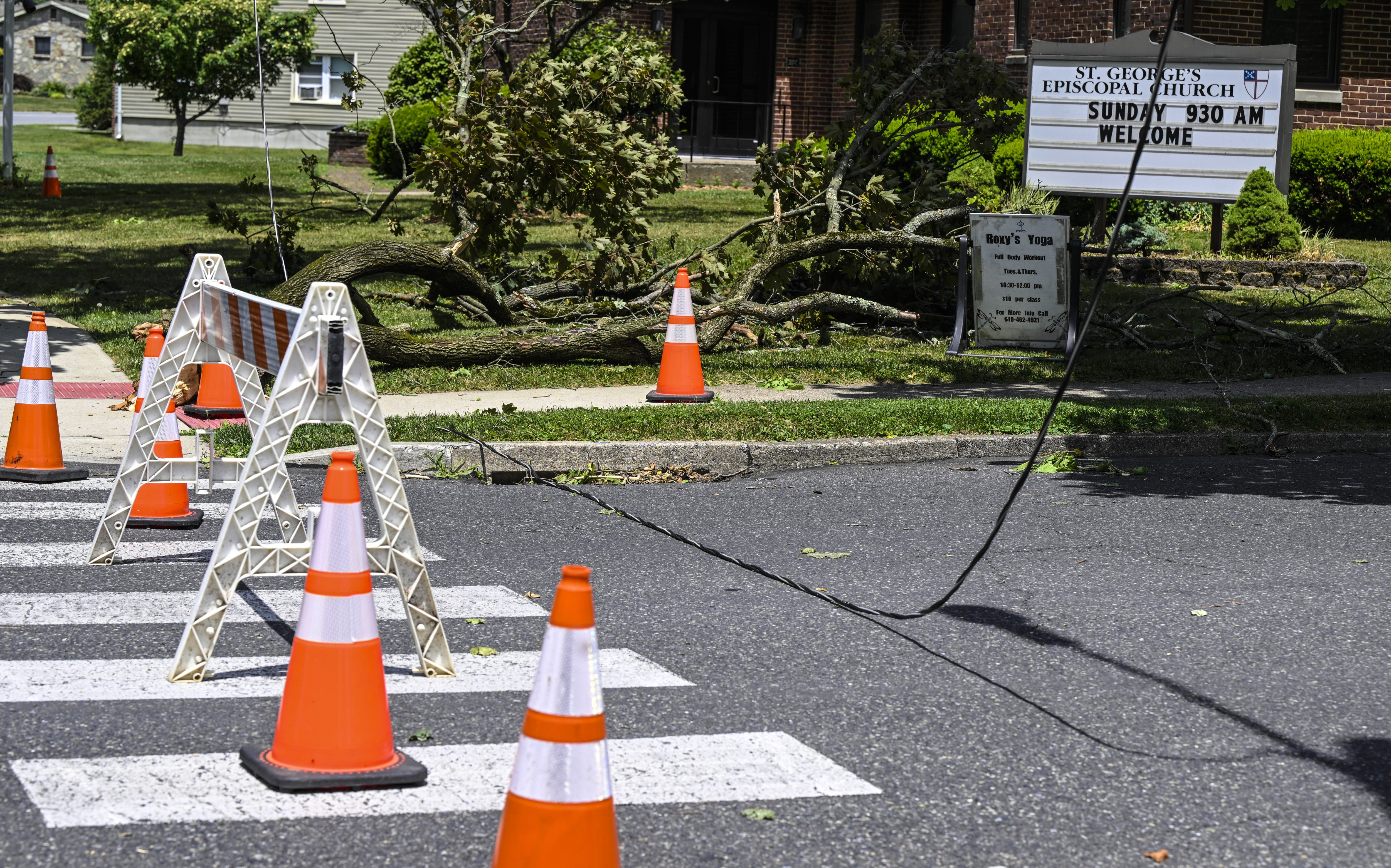 A power line is still down and Delaware Avenue is closed near St. George's Episcopal Church Thursday, June 27, 2024, in Hellertown after a severe thunderstorm with nearly 60 mph wind gusts ripped through the Lehigh Valley the night before. (Monica Cabrera/Special to The Morning Call)