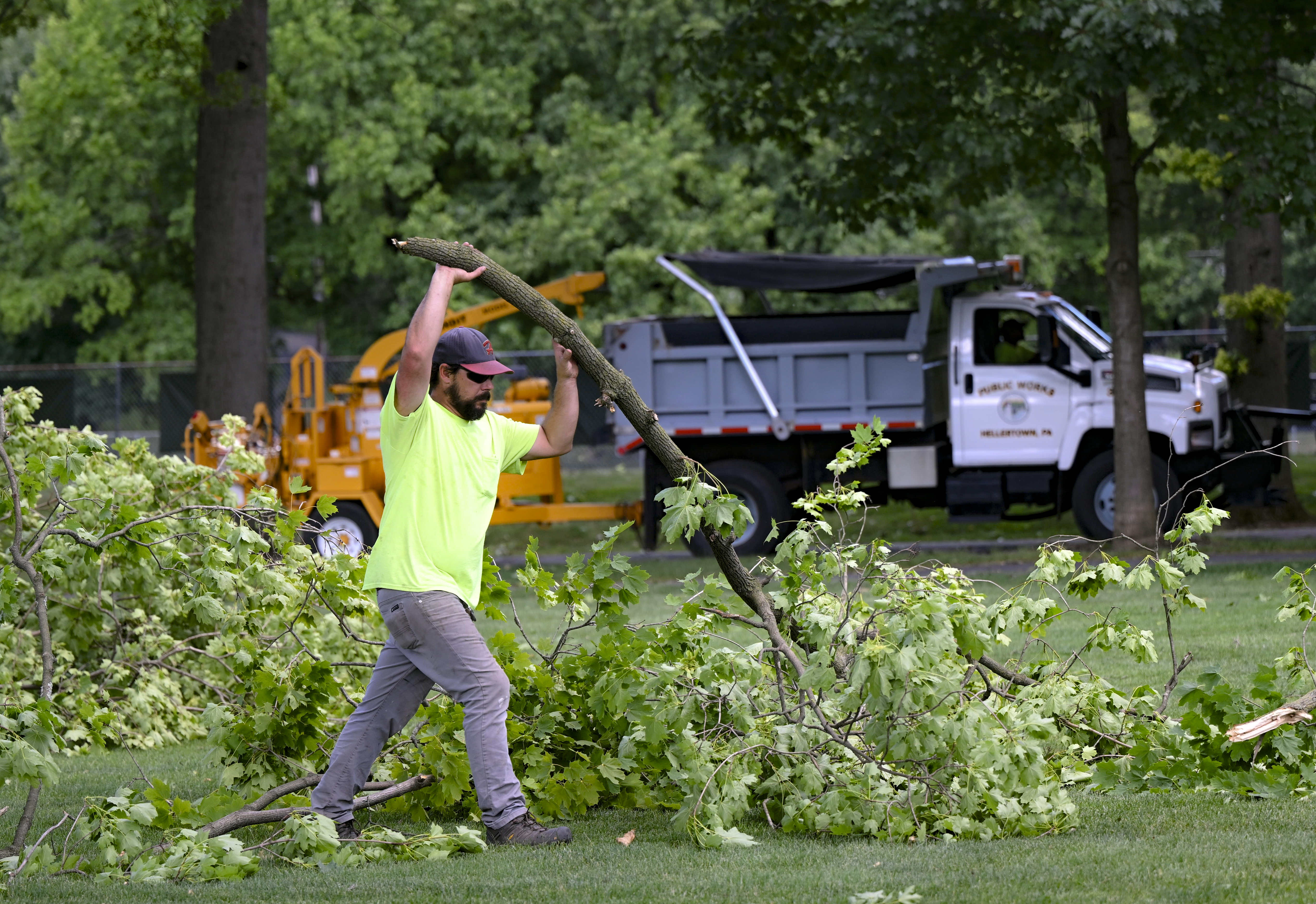 James Edge with Public Works picks up tree limbs and debris Thursday, June 27, 2024, at Dimmick Park in Hellertown after a severe thunderstorm with nearly 60 mph wind gusts ripped through the Lehigh Valley the night before. (Monica Cabrera/Special to The Morning Call)