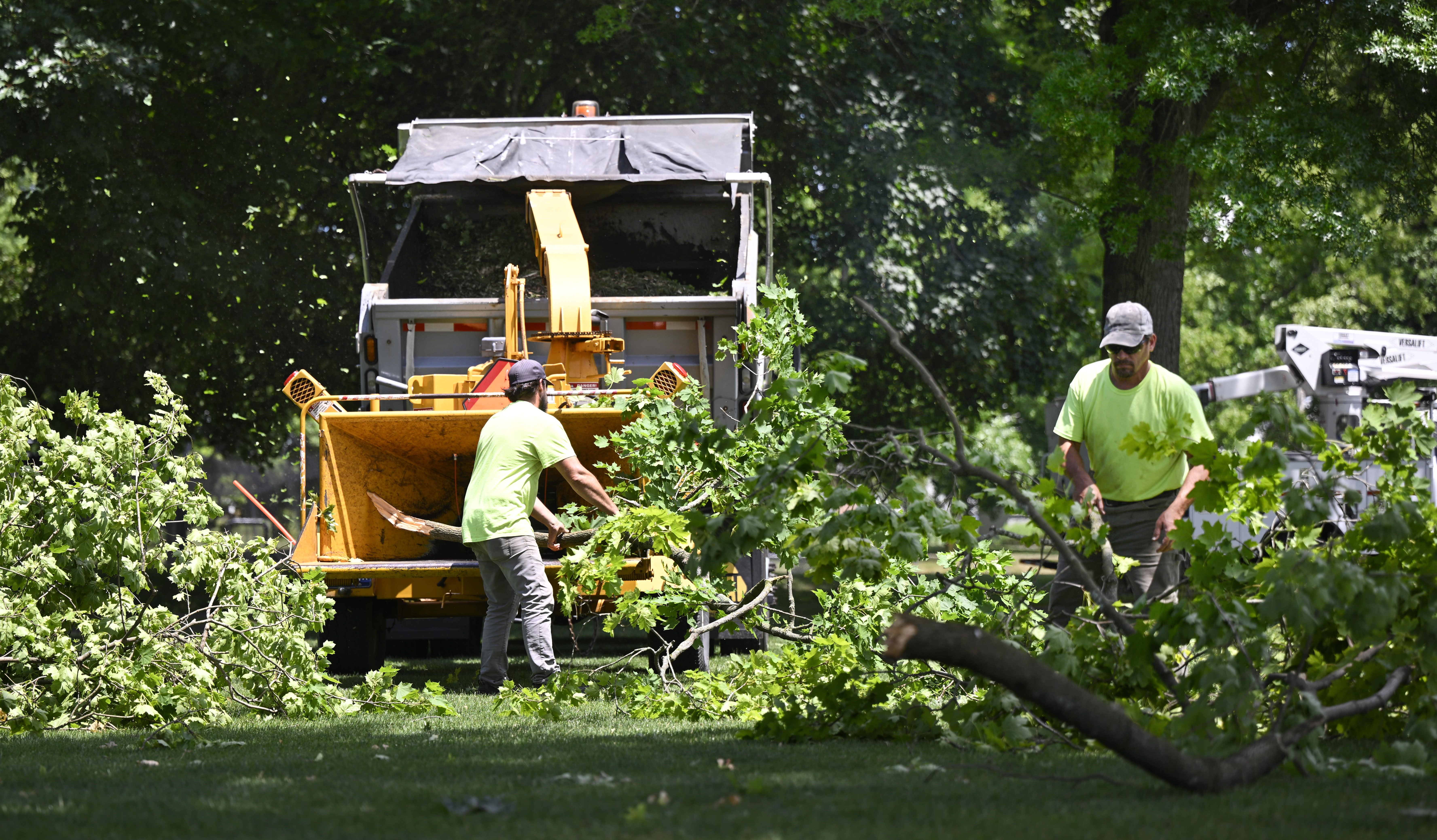 James Edge and Scott Ziegler with Public Works pick up tree limbs and debris Thursday, June 27, 2024, at Dimmick Park in Hellertown after a severe thunderstorm with nearly 60 mph wind gusts ripped through the Lehigh Valley the night before. (Monica Cabrera/Special to The Morning Call)